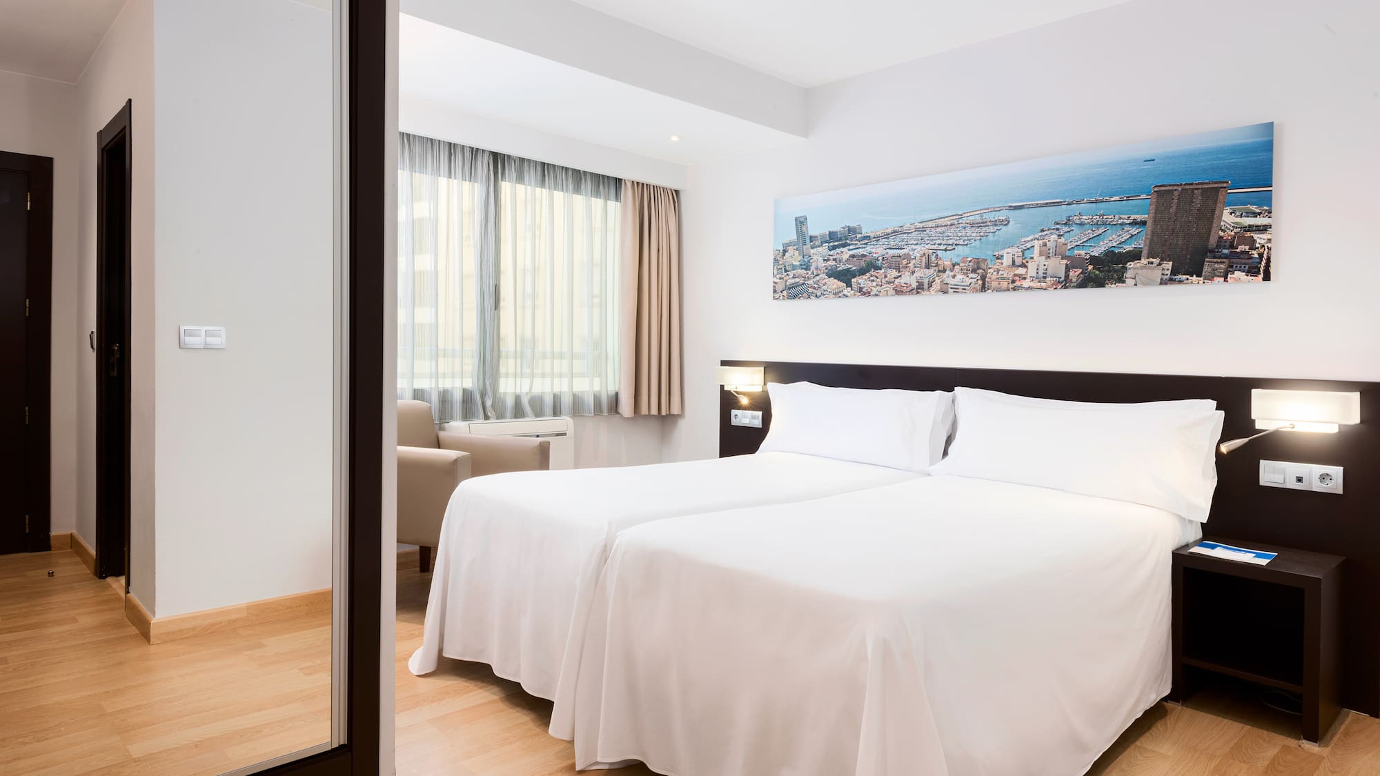 a room with two beds and a mirror