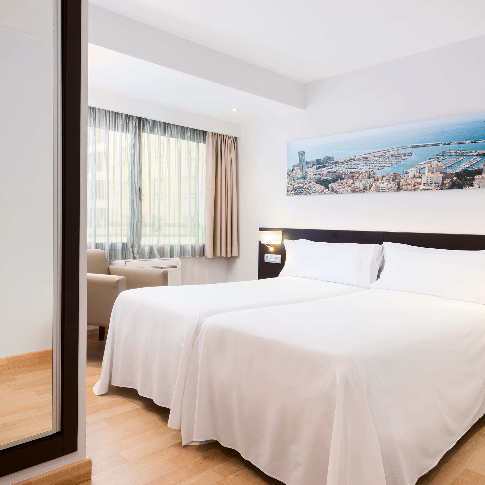 a room with two beds and a mirror