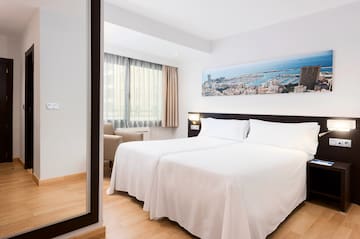 a room with two beds and a mirror