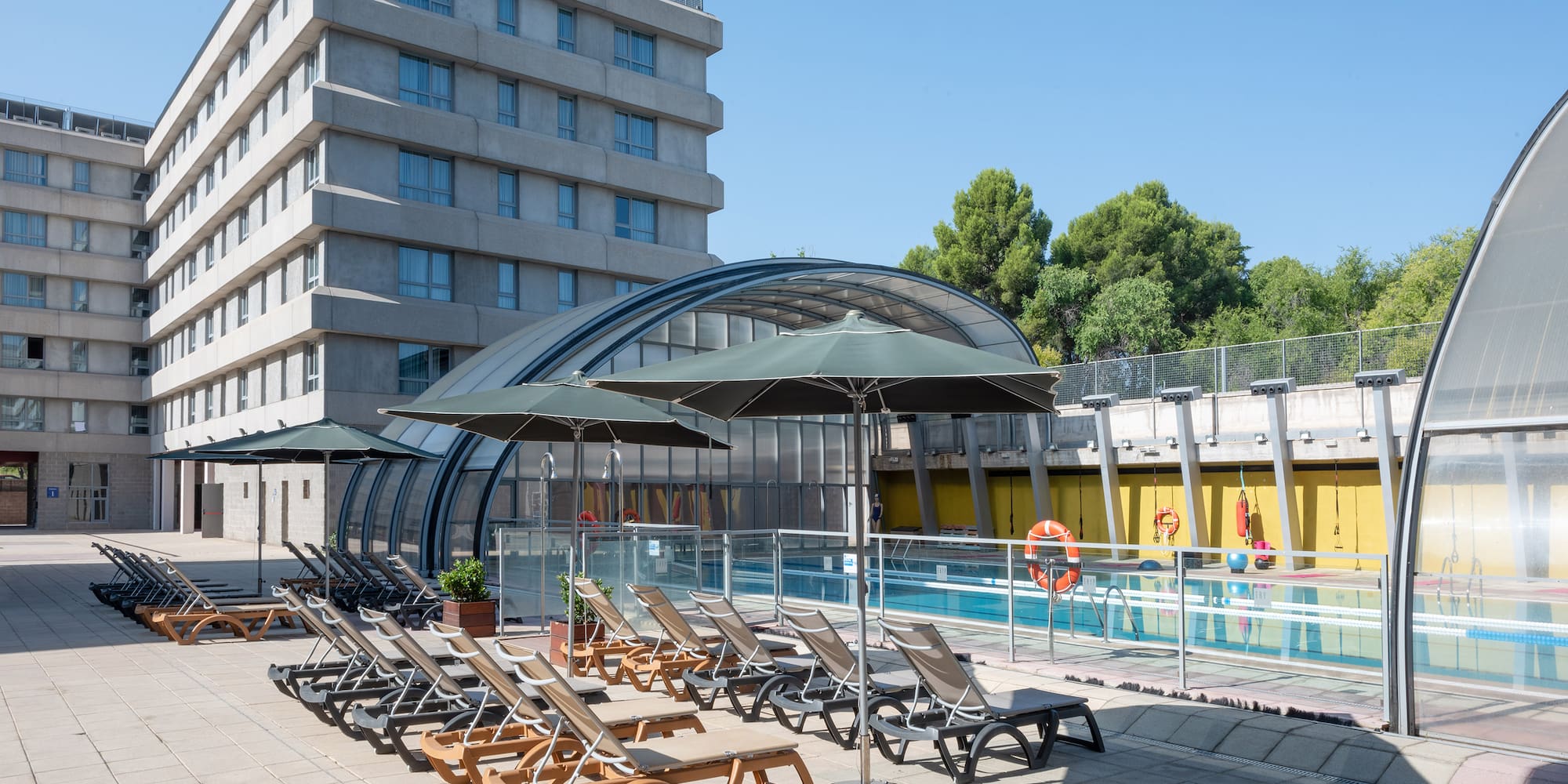 a pool with chairs and umbrellas