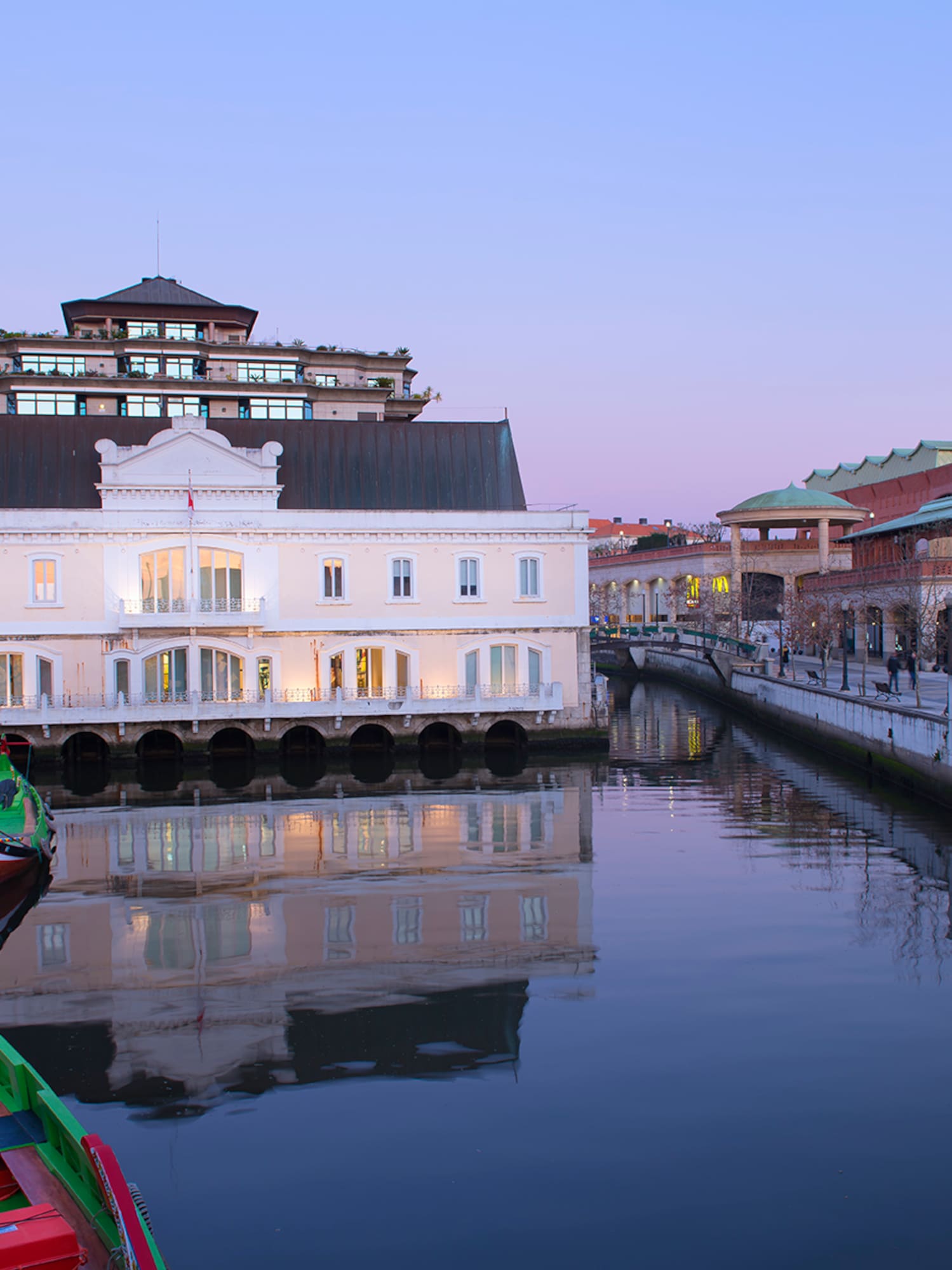 a water way with boats and buildings in the background