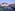 a water way with boats and buildings in the background