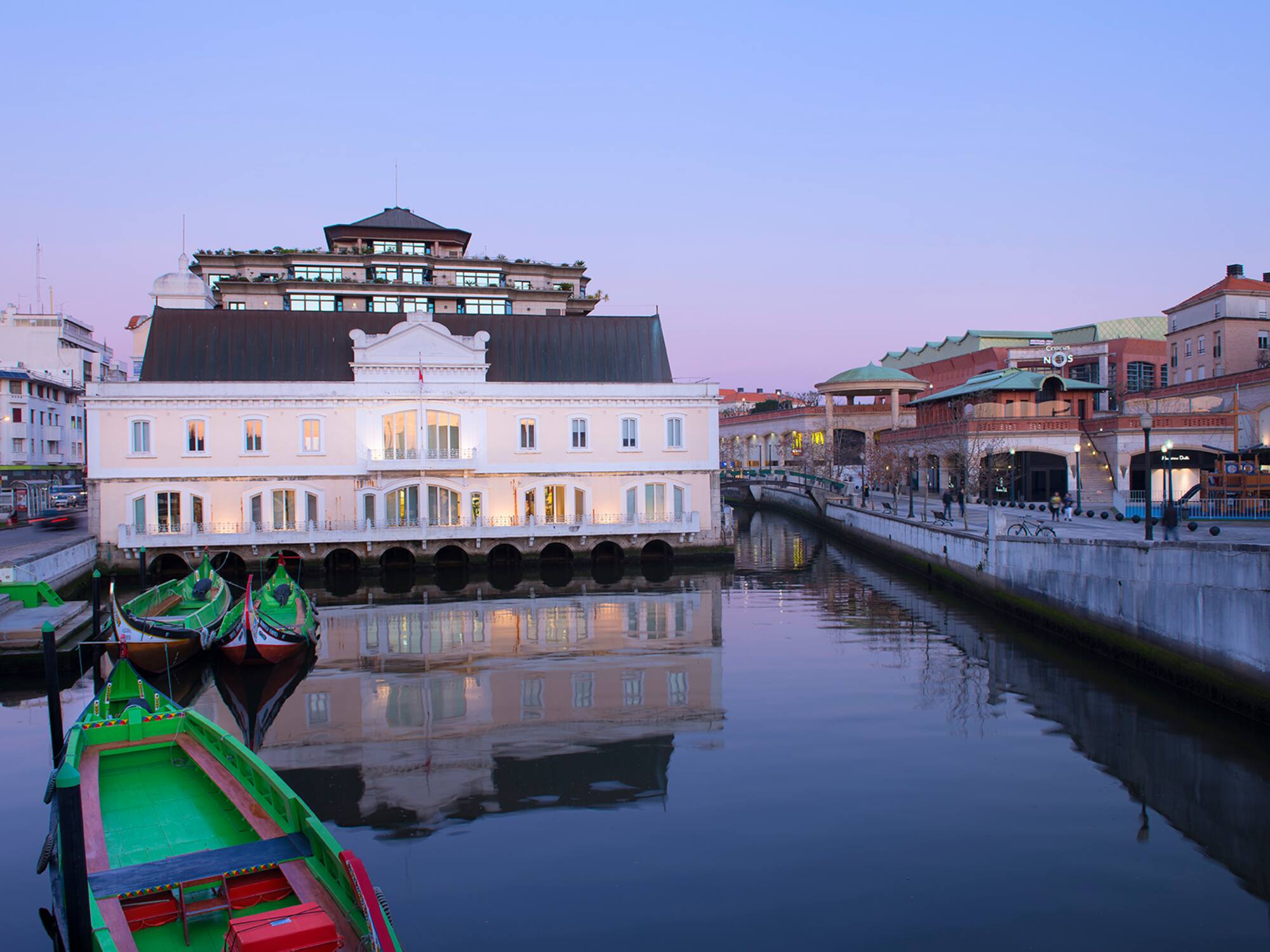 a water way with boats and buildings in the background