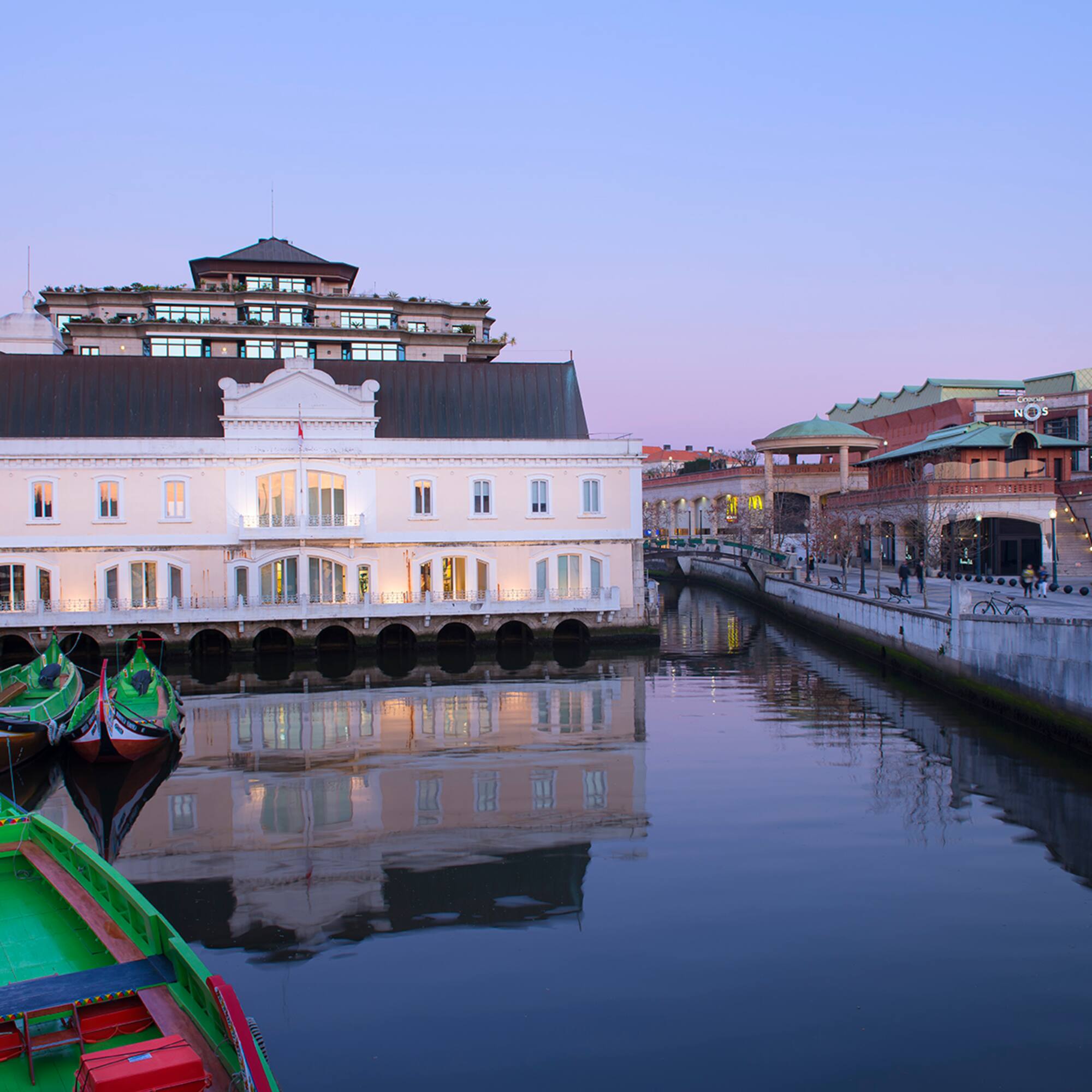 a water way with boats and buildings in the background