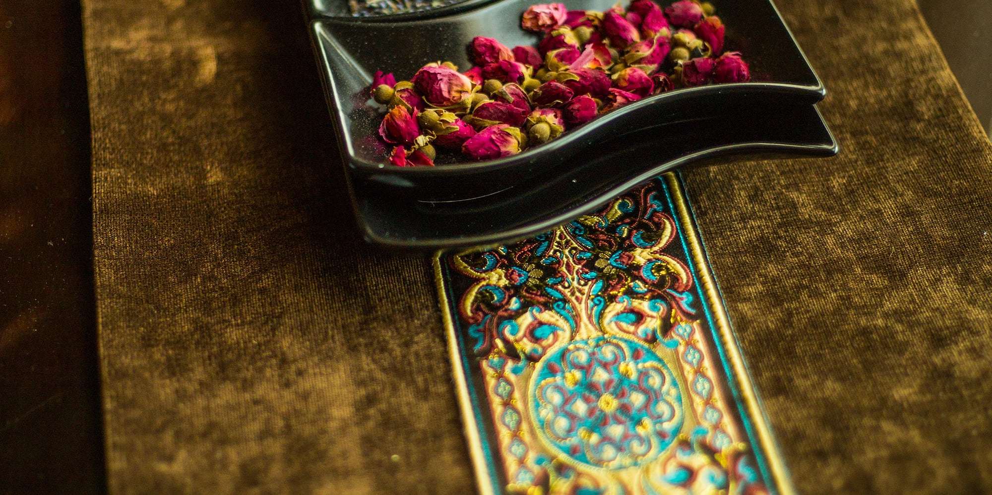 a row of bowls with dried flowers