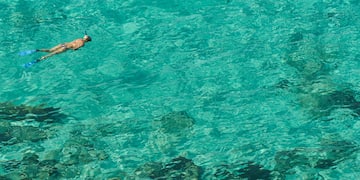 a person swimming in clear water