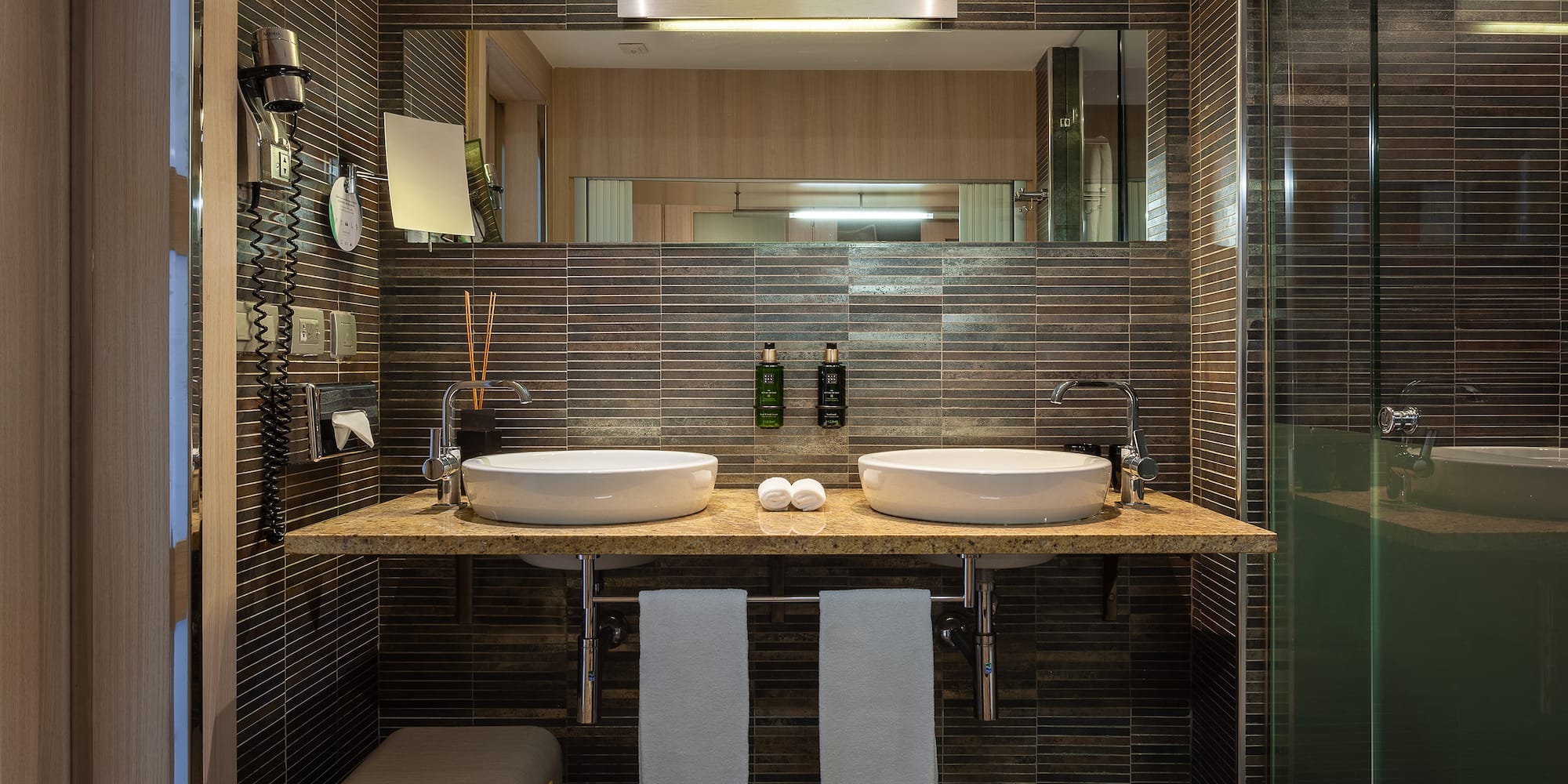 a bathroom with two sinks and a mirror