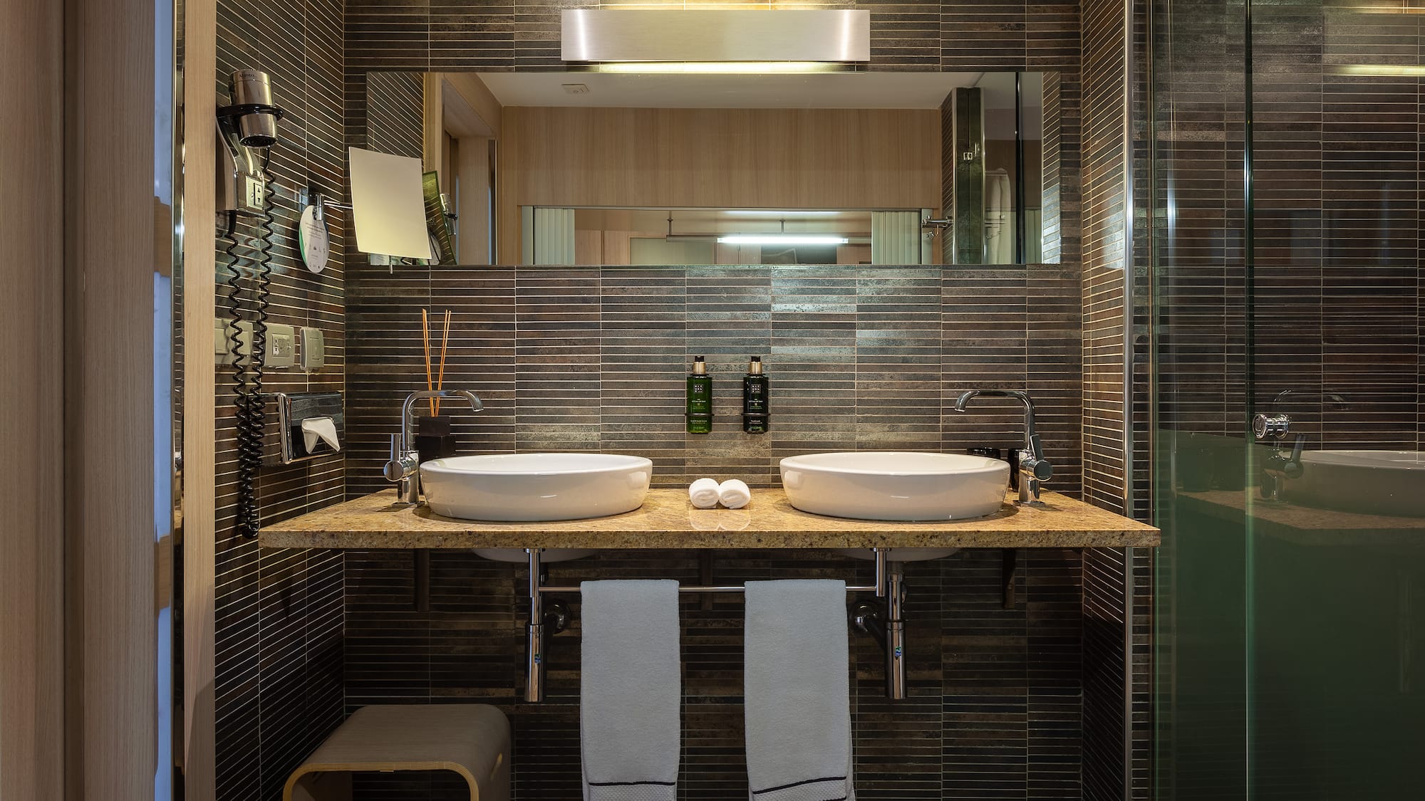 a bathroom with two sinks and a mirror
