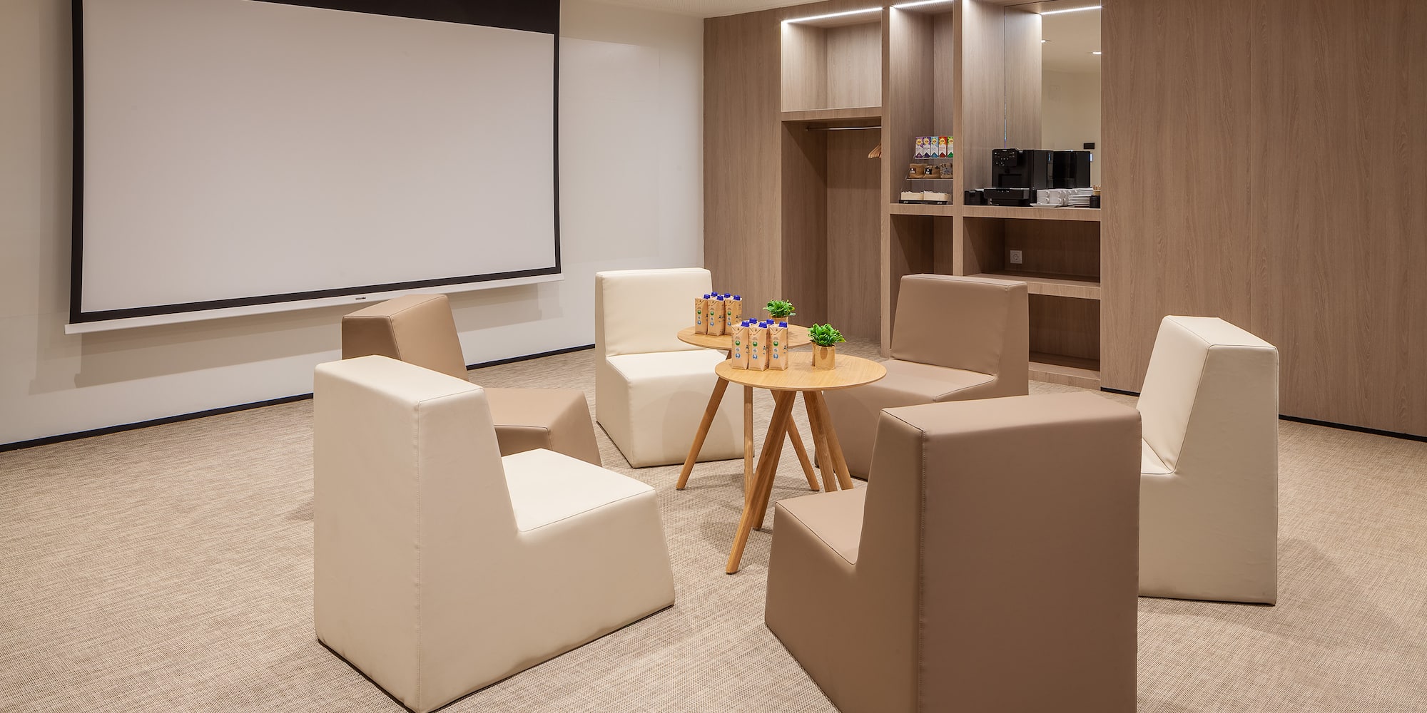 a room with a projector screen and chairs