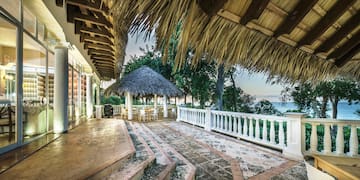 a patio with a thatched roof and a thatched roof