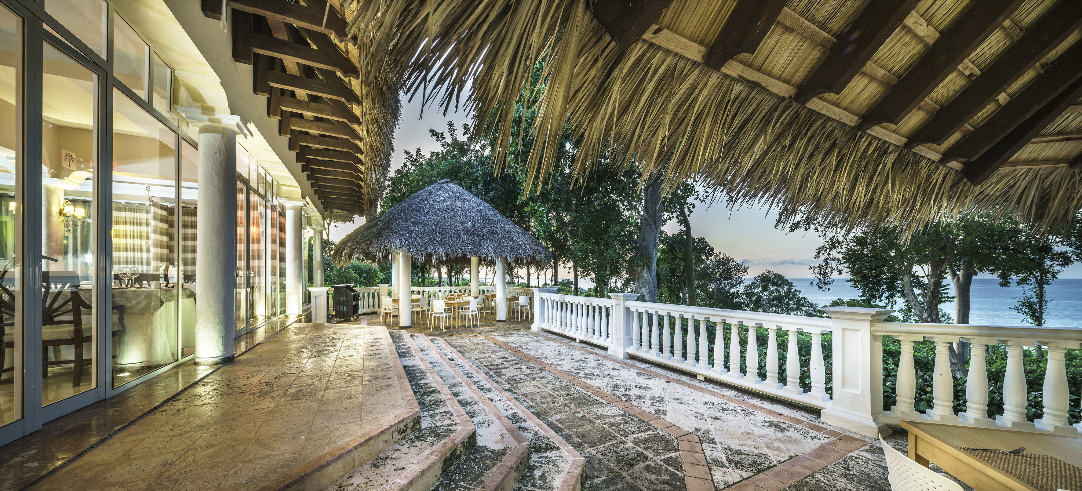 a patio with a thatched roof and a thatched roof