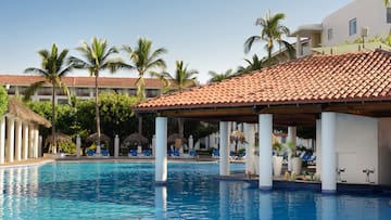 a pool with a roof and chairs