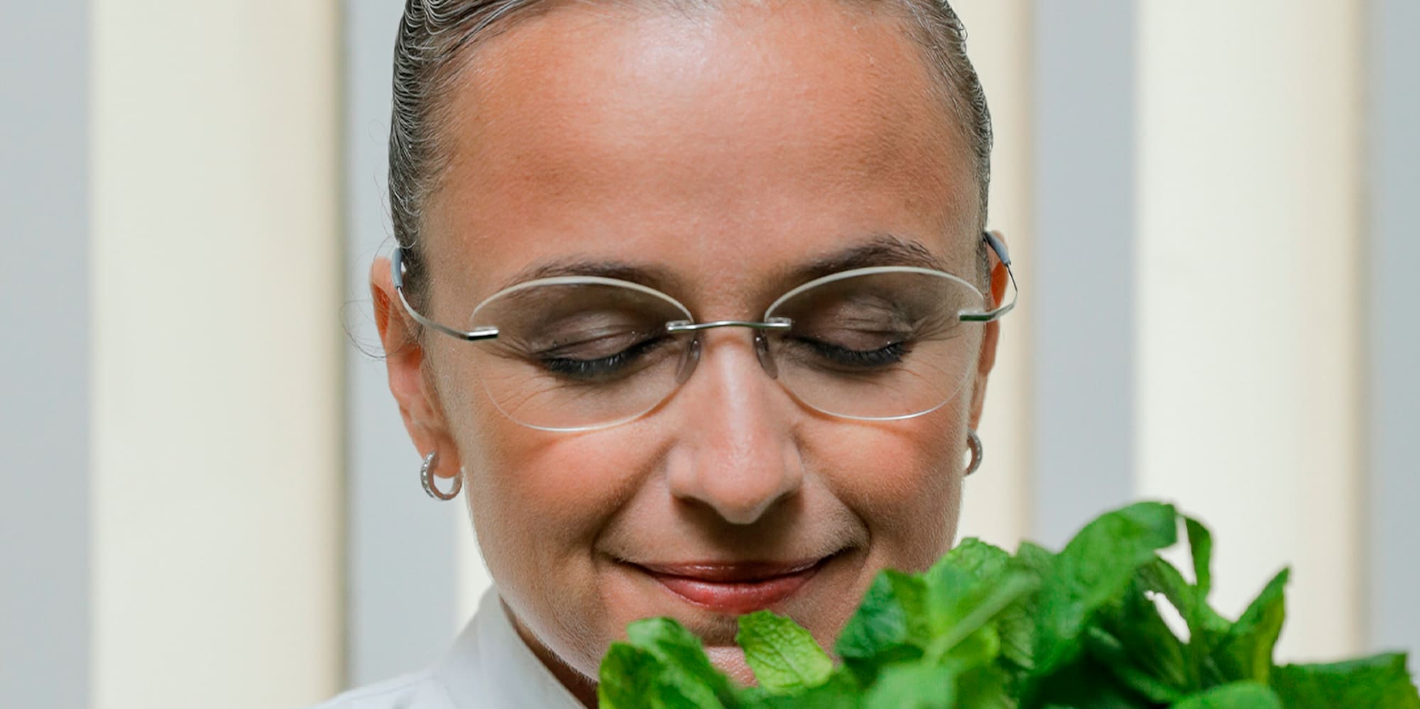 a woman looking at a bunch of leaves