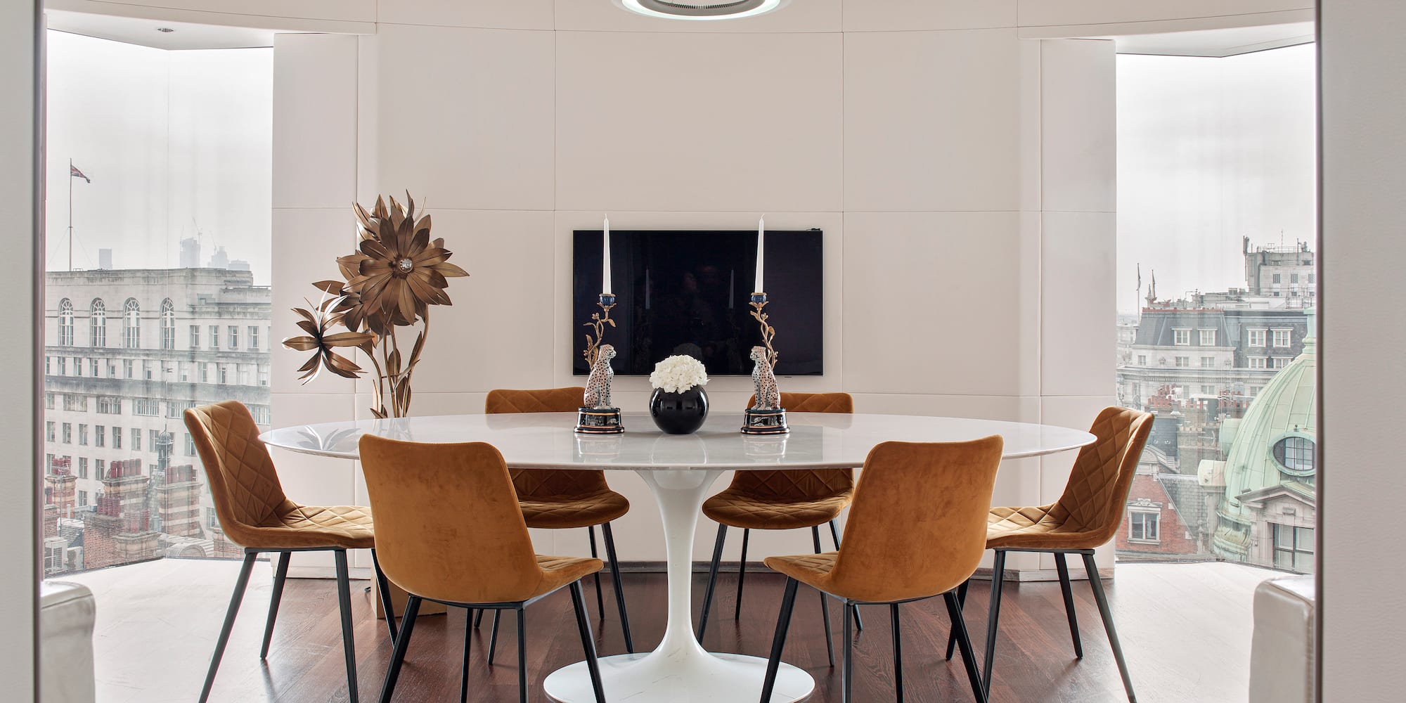 a room with a round table and chairs