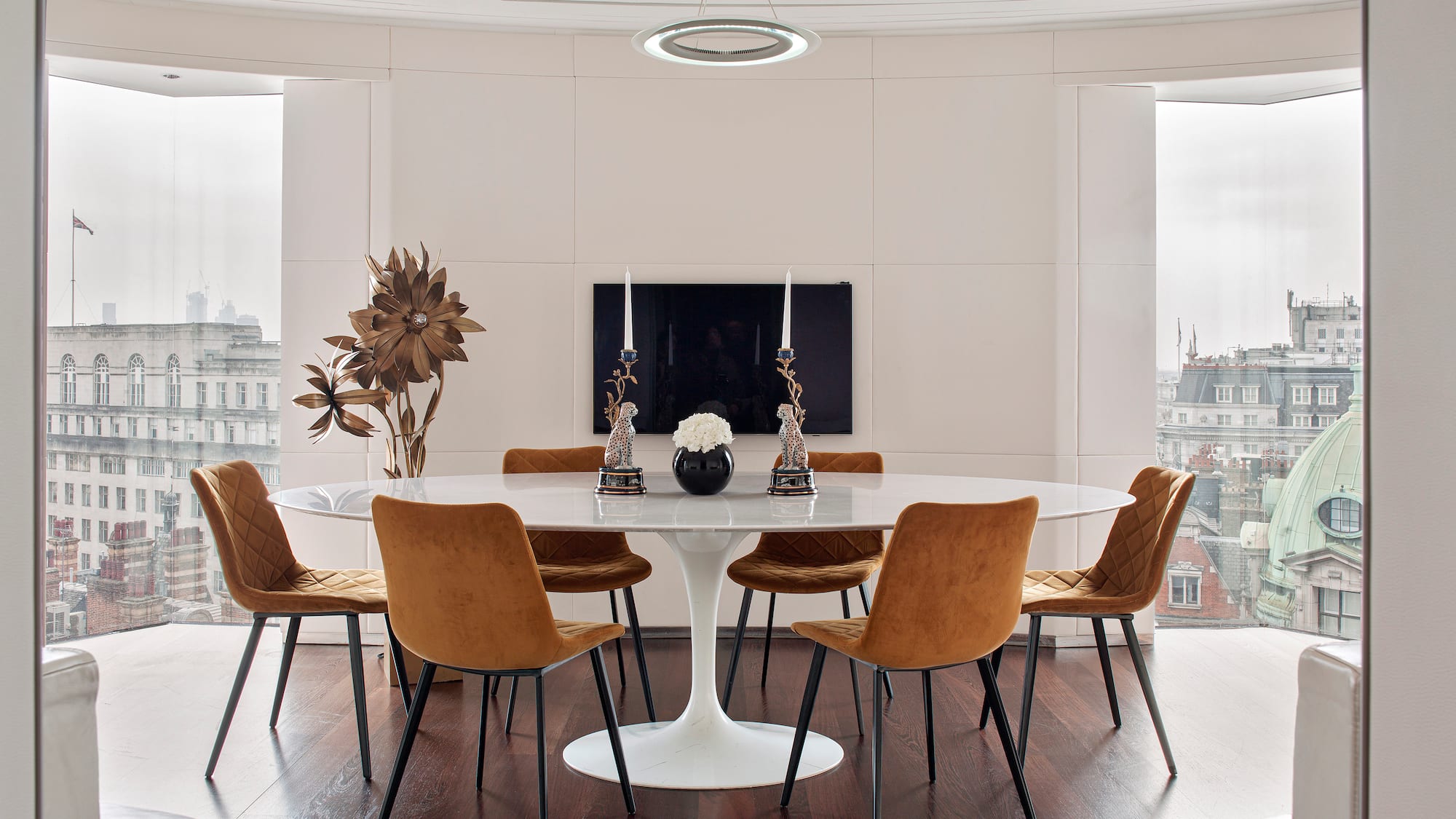 a room with a round table and chairs