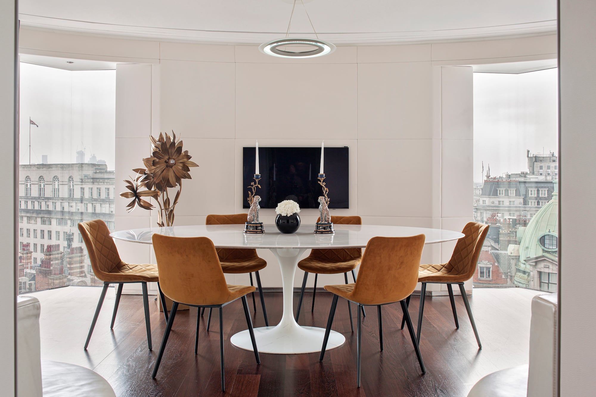 a room with a round table and chairs