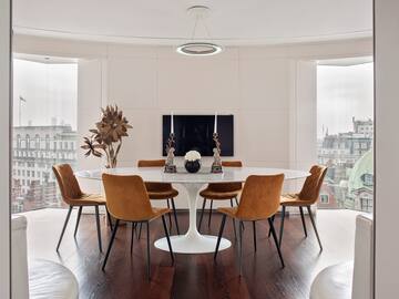 a room with a round table and chairs