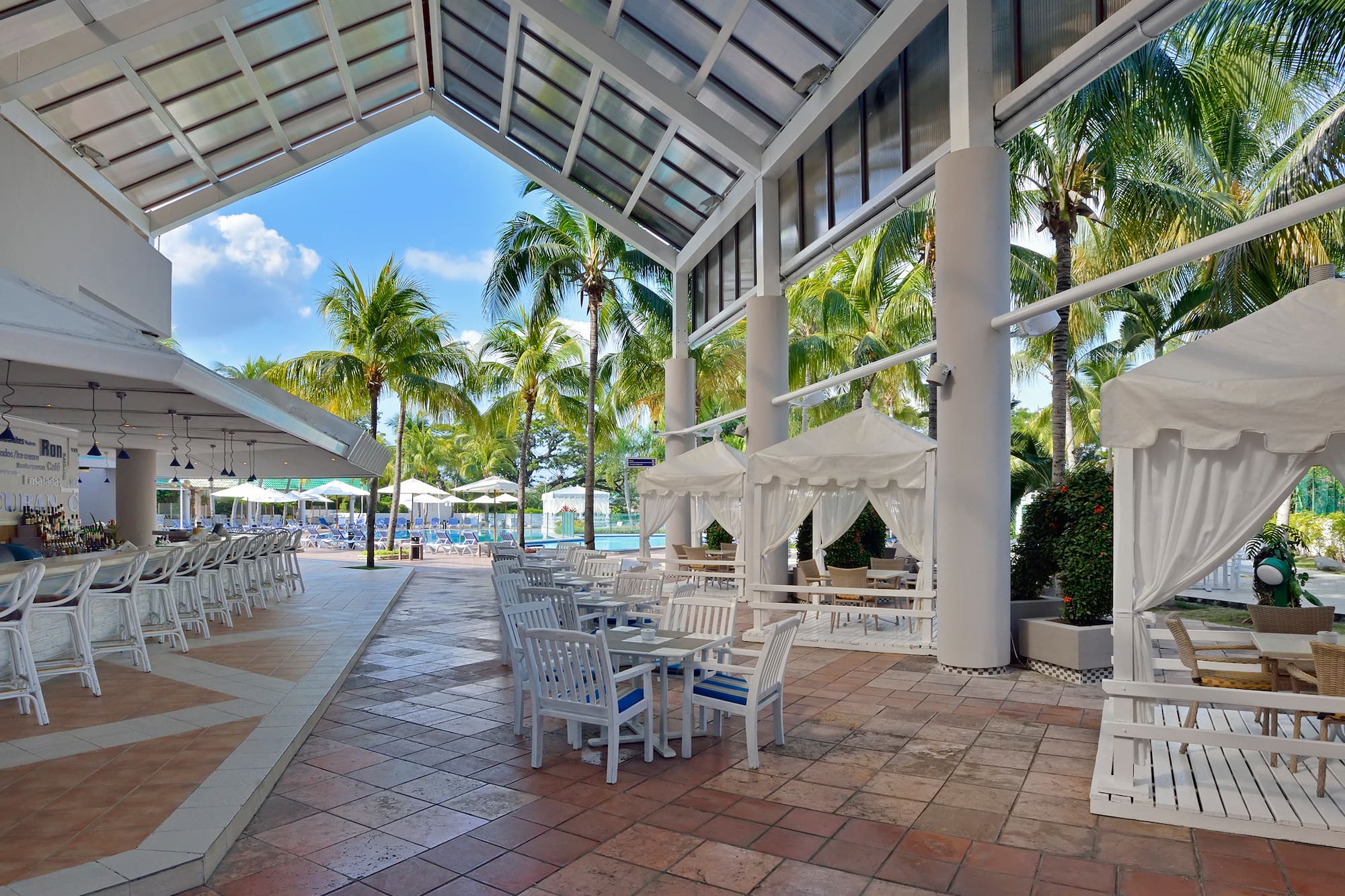 a patio with tables and chairs and umbrellas