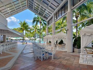 a patio with tables and chairs and umbrellas