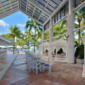 a patio with tables and chairs and umbrellas