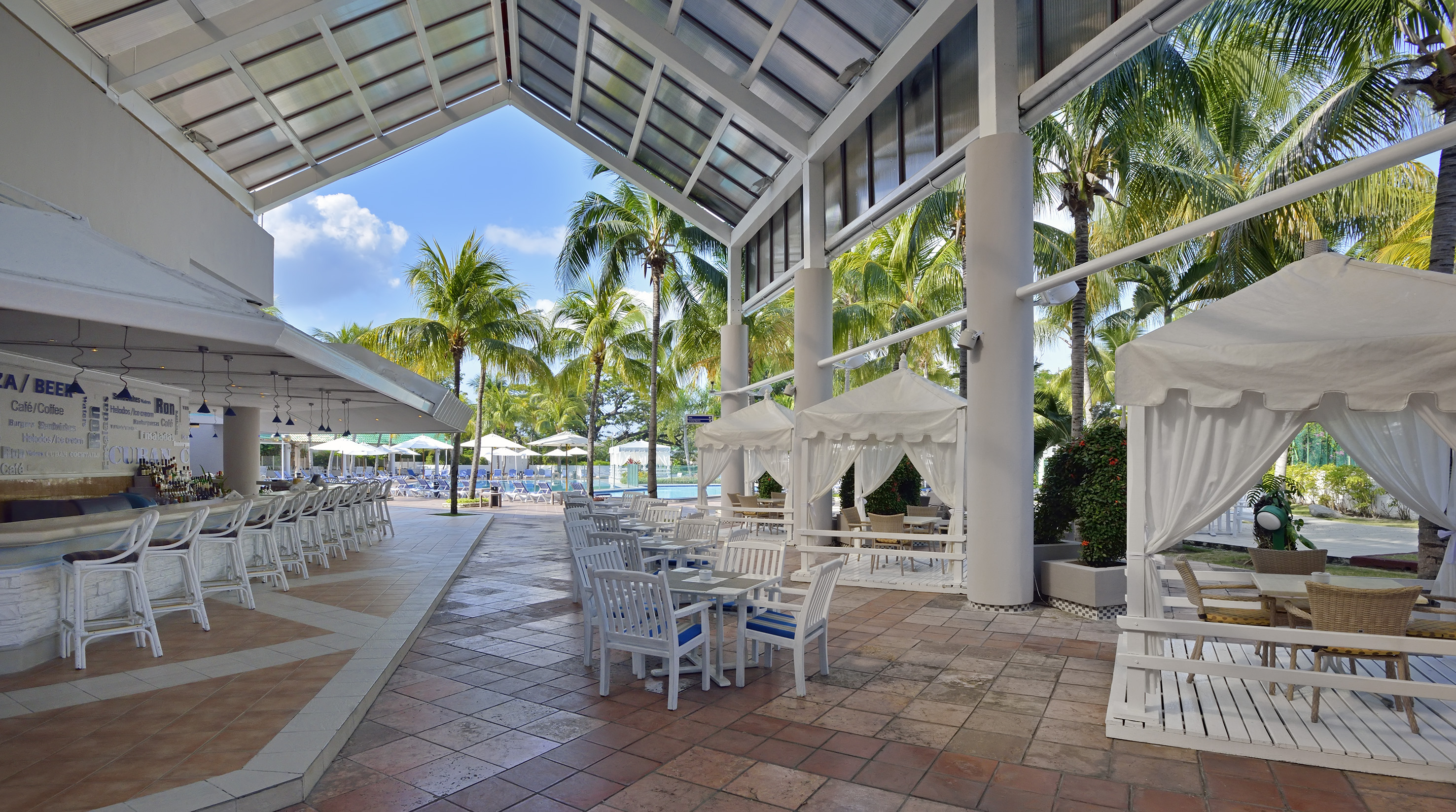 a patio with tables and chairs and umbrellas