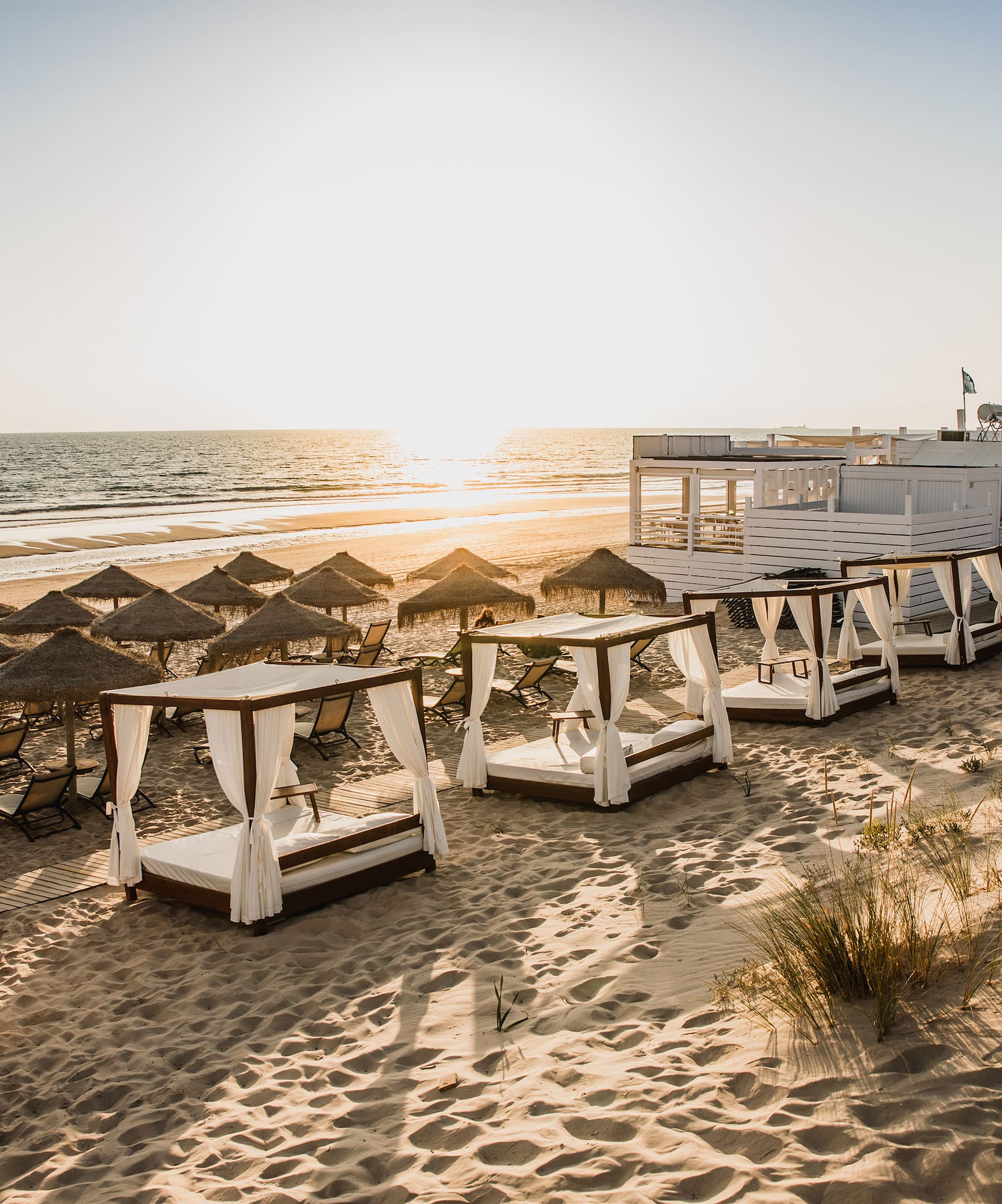 a beach with umbrellas and chairs