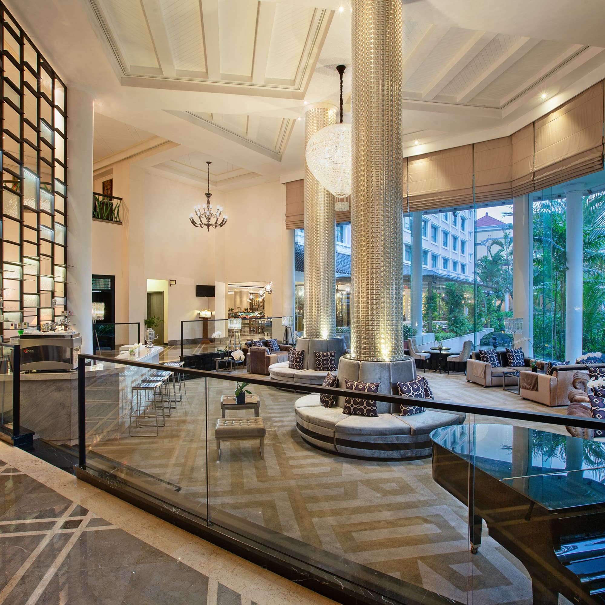 a large room with glass railings and a large chandelier