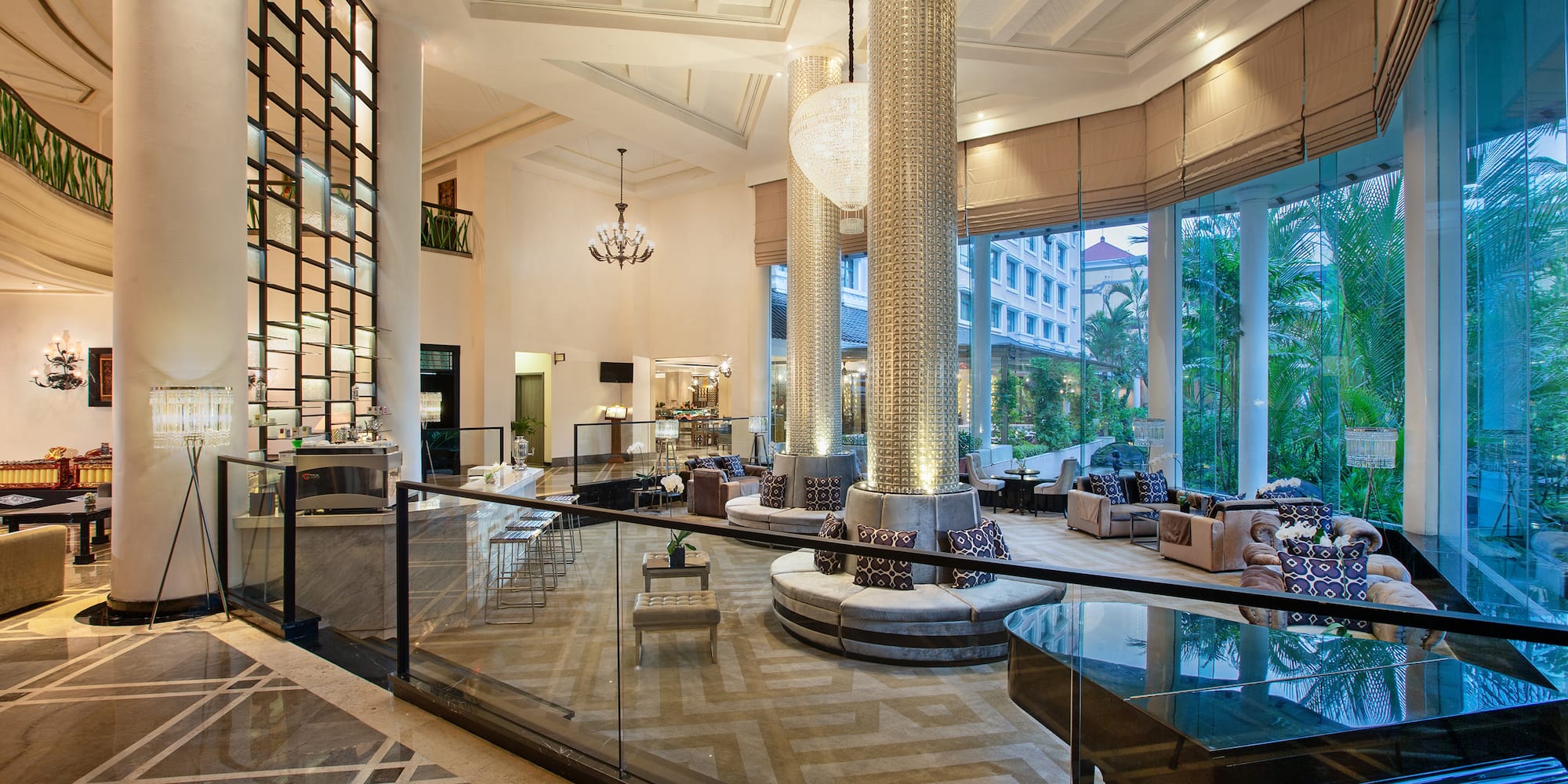 a large room with glass railings and a large chandelier