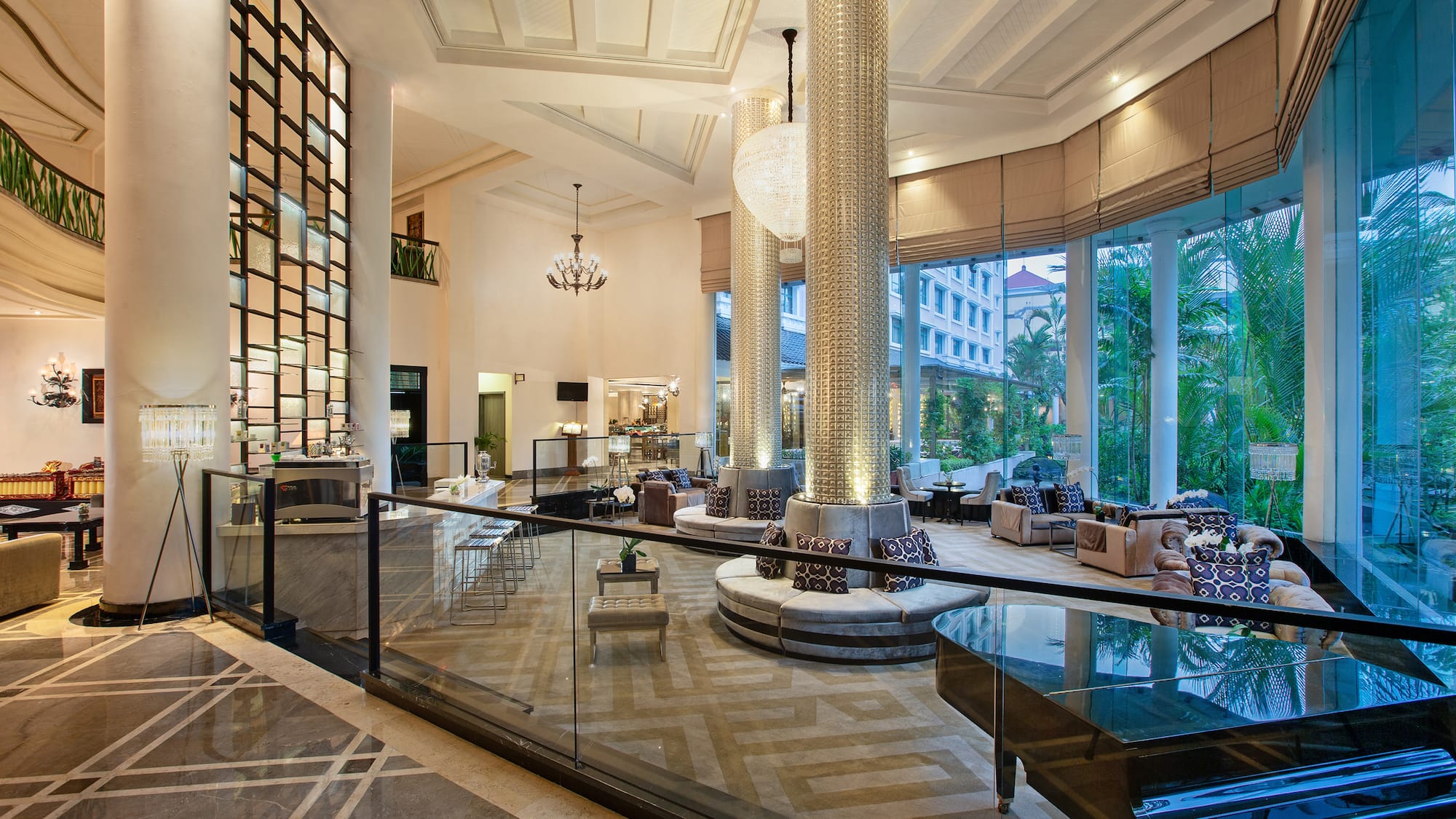 a large room with glass railings and a large chandelier
