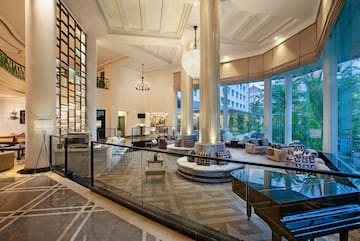 a large room with glass railings and a large chandelier