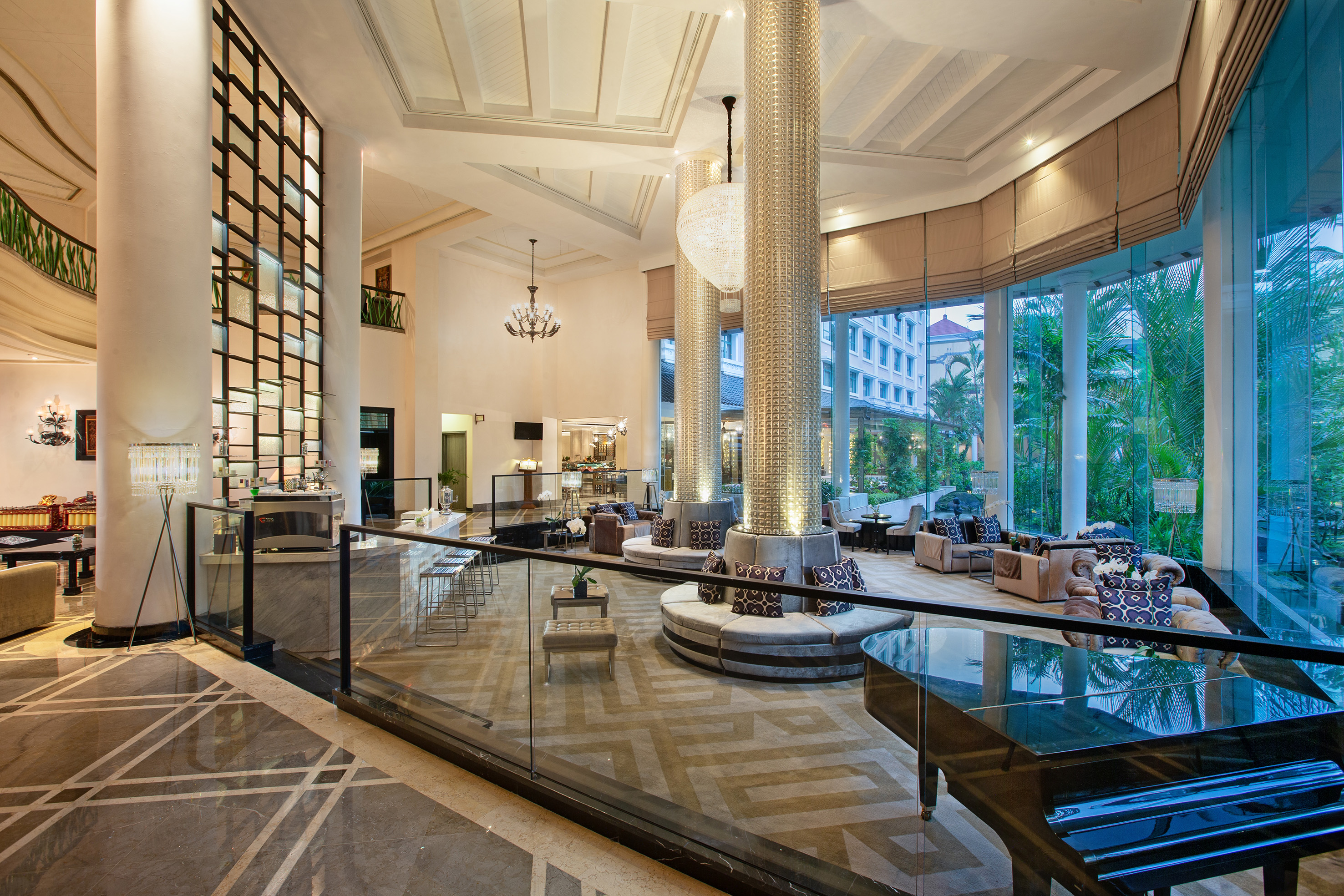 a large room with glass railings and a large chandelier