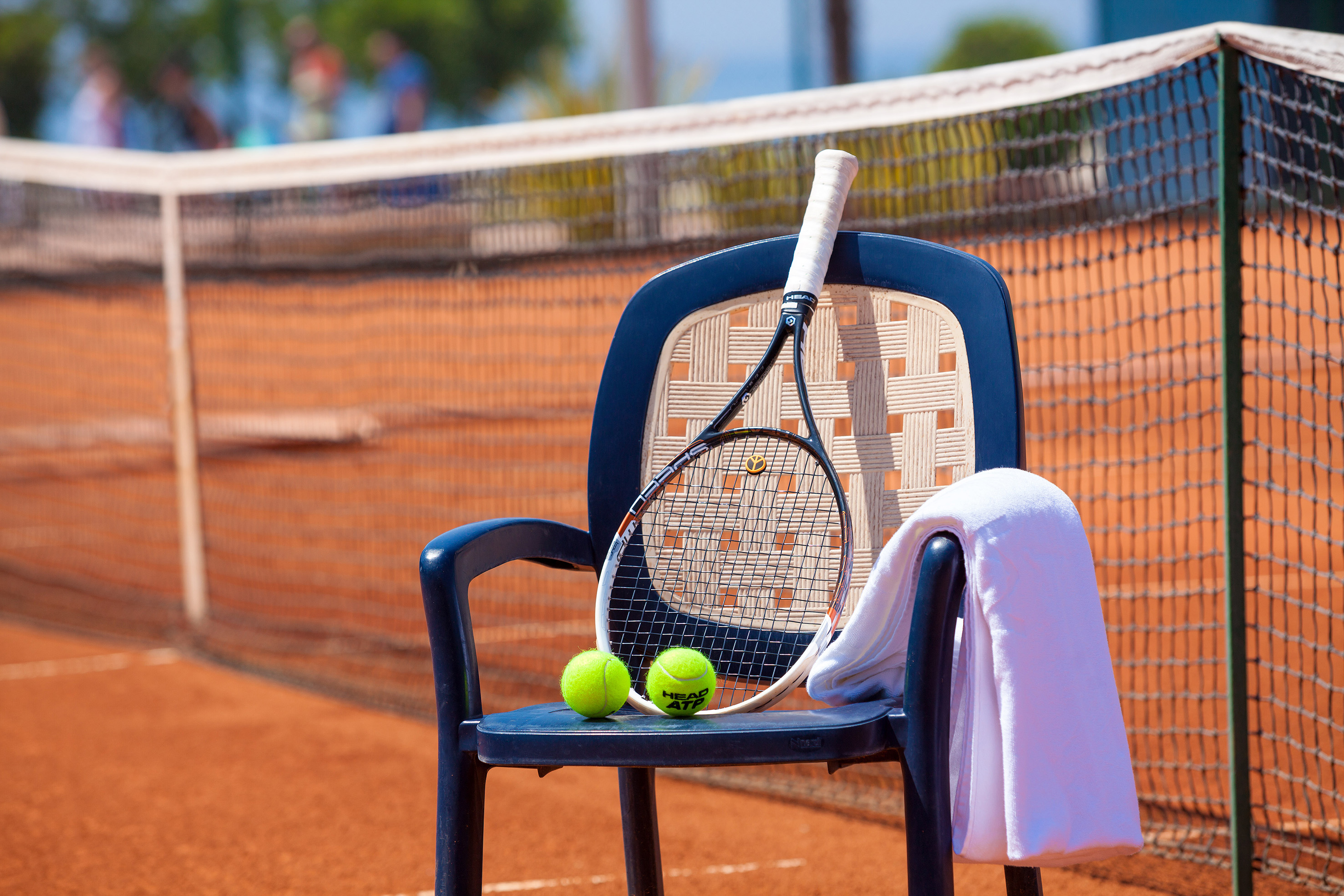 a tennis racket and balls on a chair