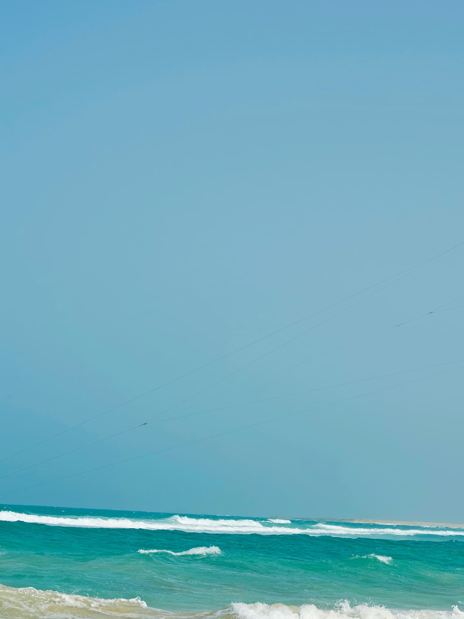 a person flying a kite over the ocean