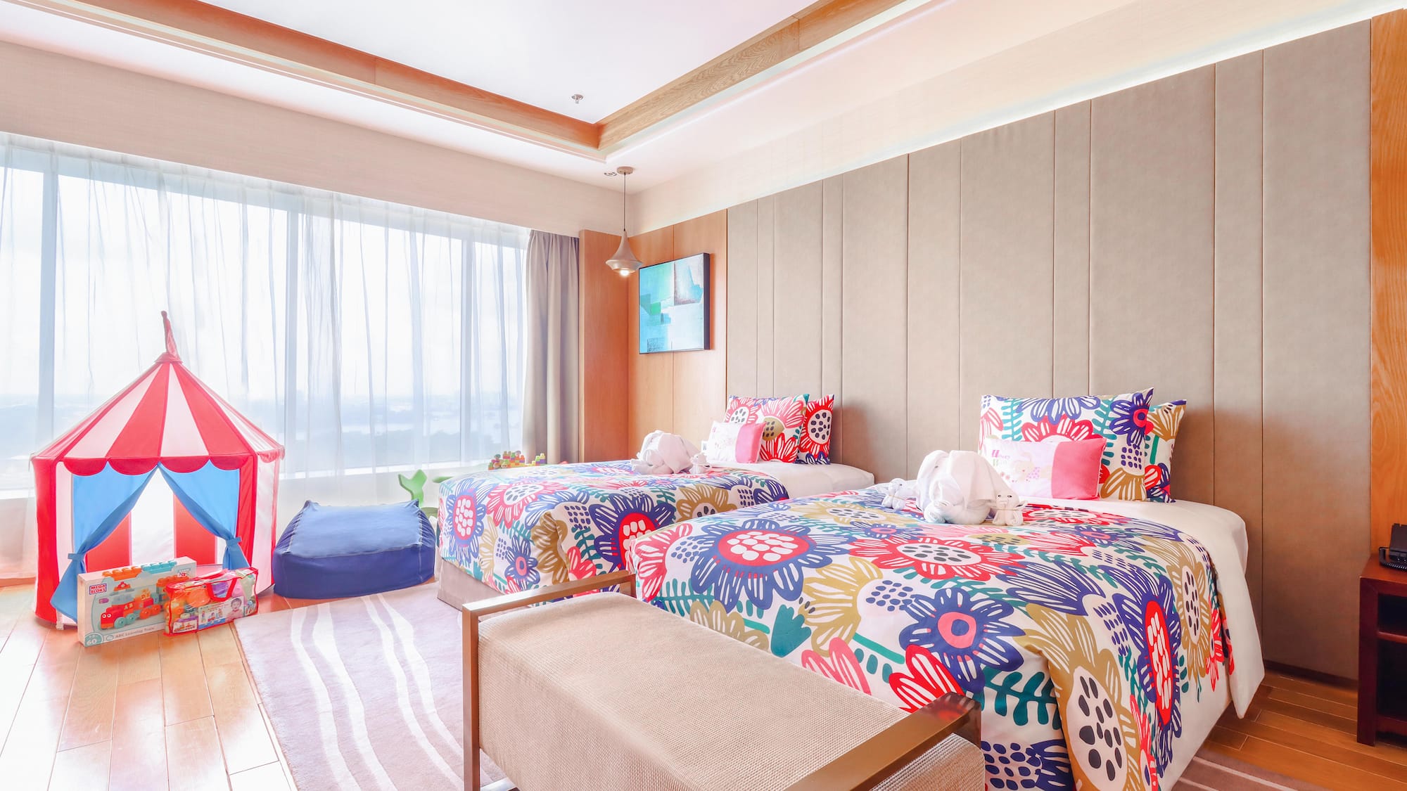 a room with two beds and a pink tent