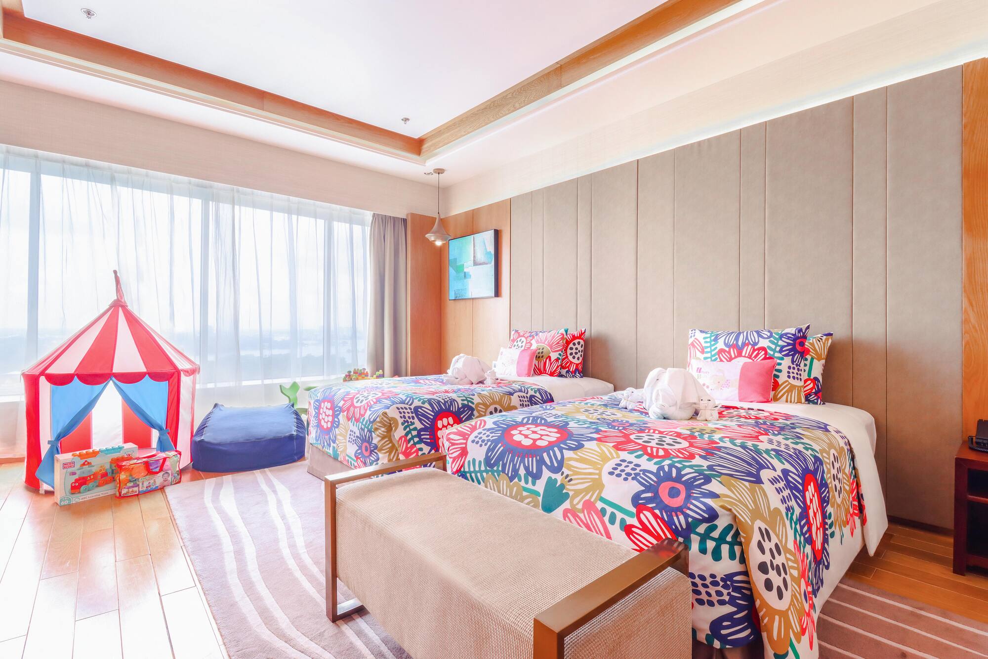 a room with two beds and a pink tent