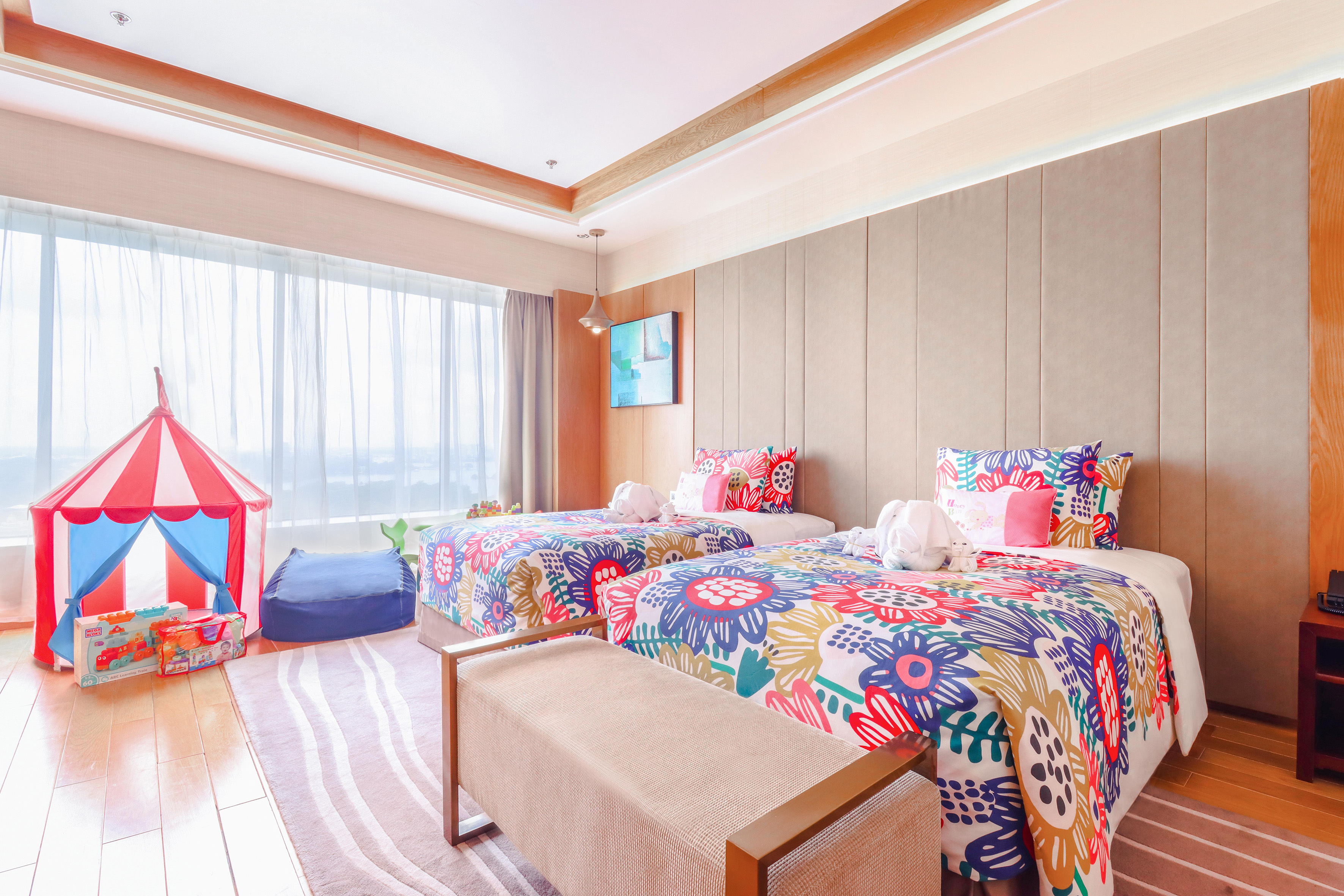 a room with two beds and a pink tent