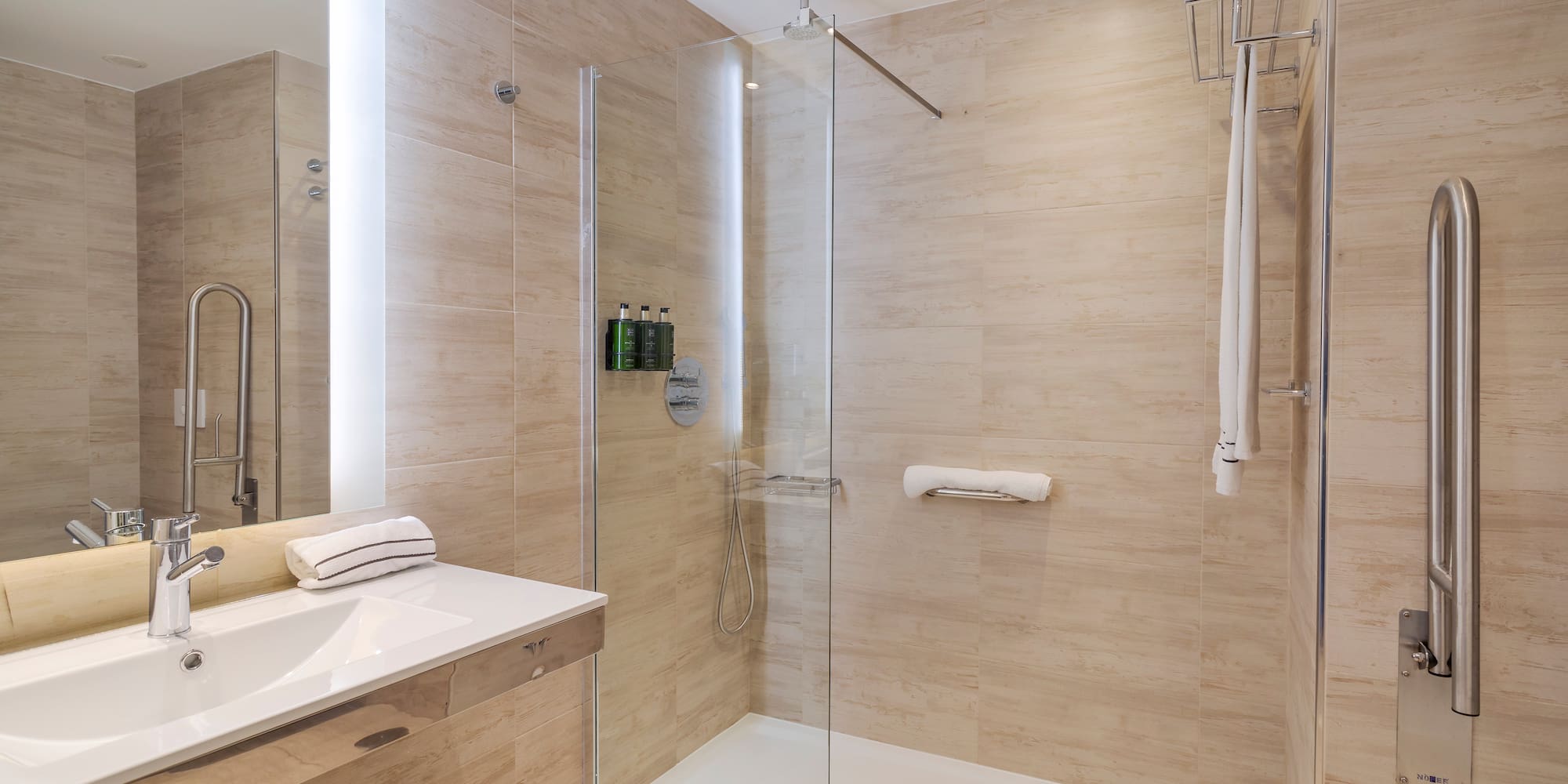 a bathroom with a glass shower and sink
