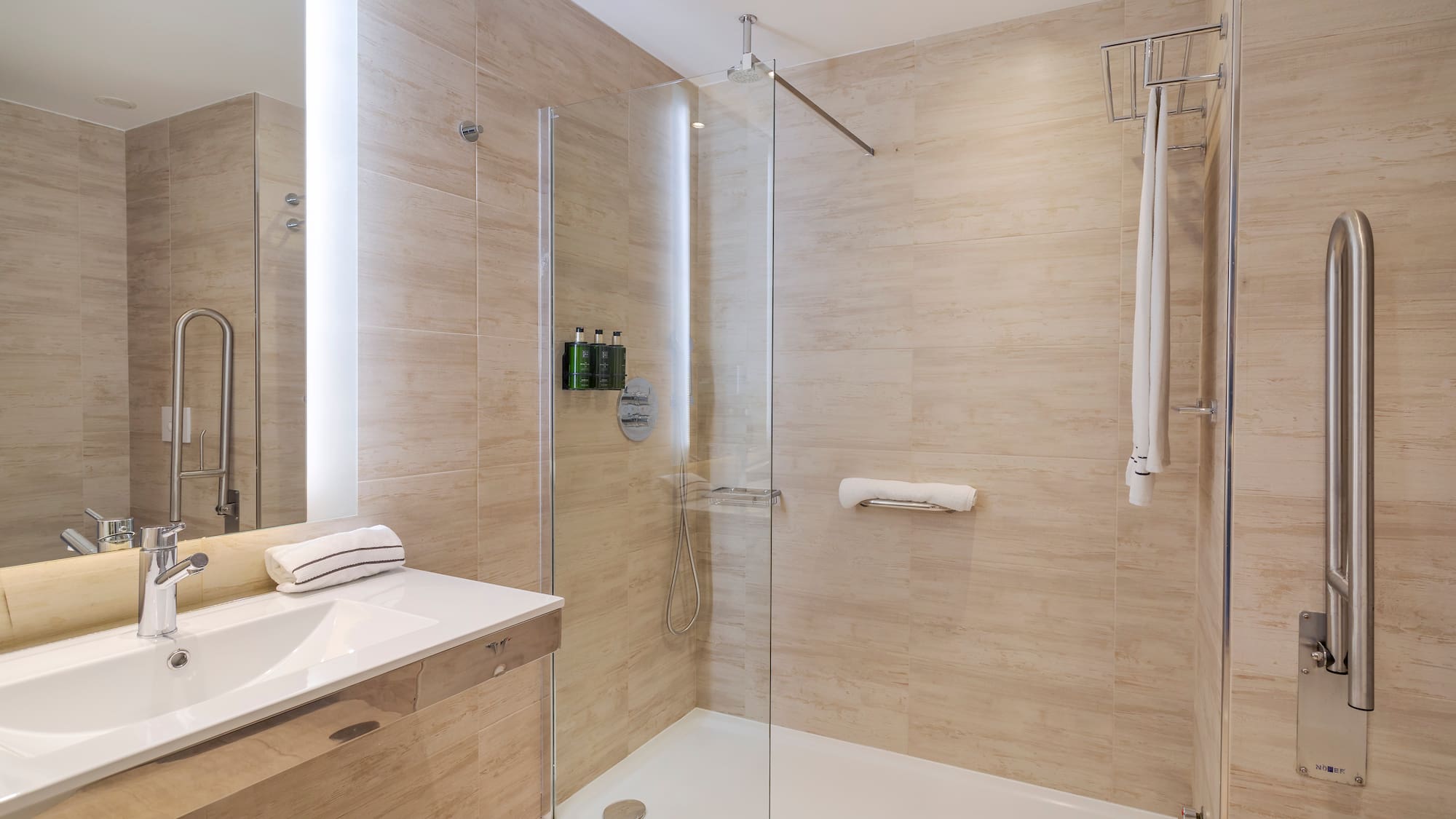 a bathroom with a glass shower and sink