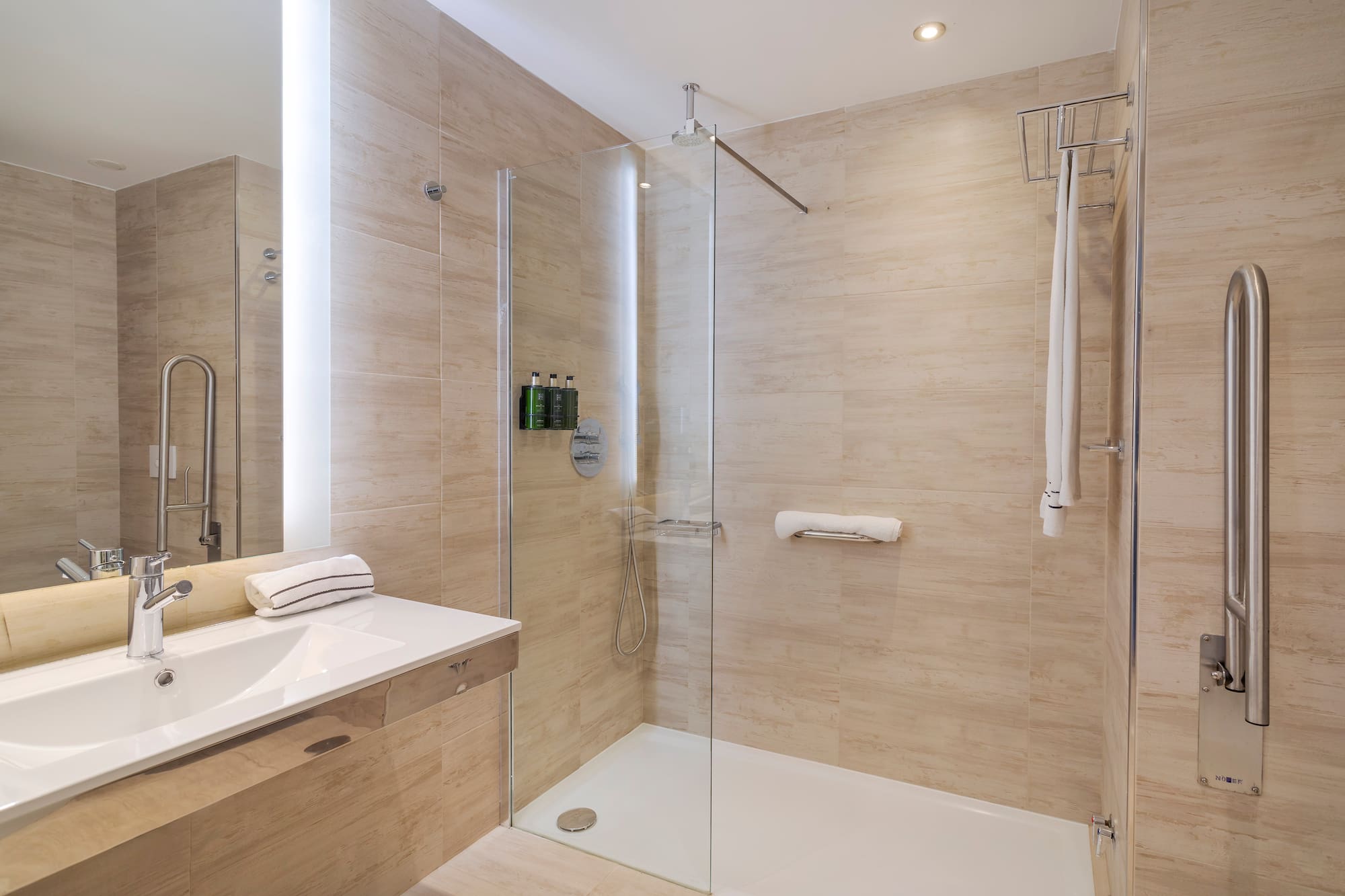 a bathroom with a glass shower and sink
