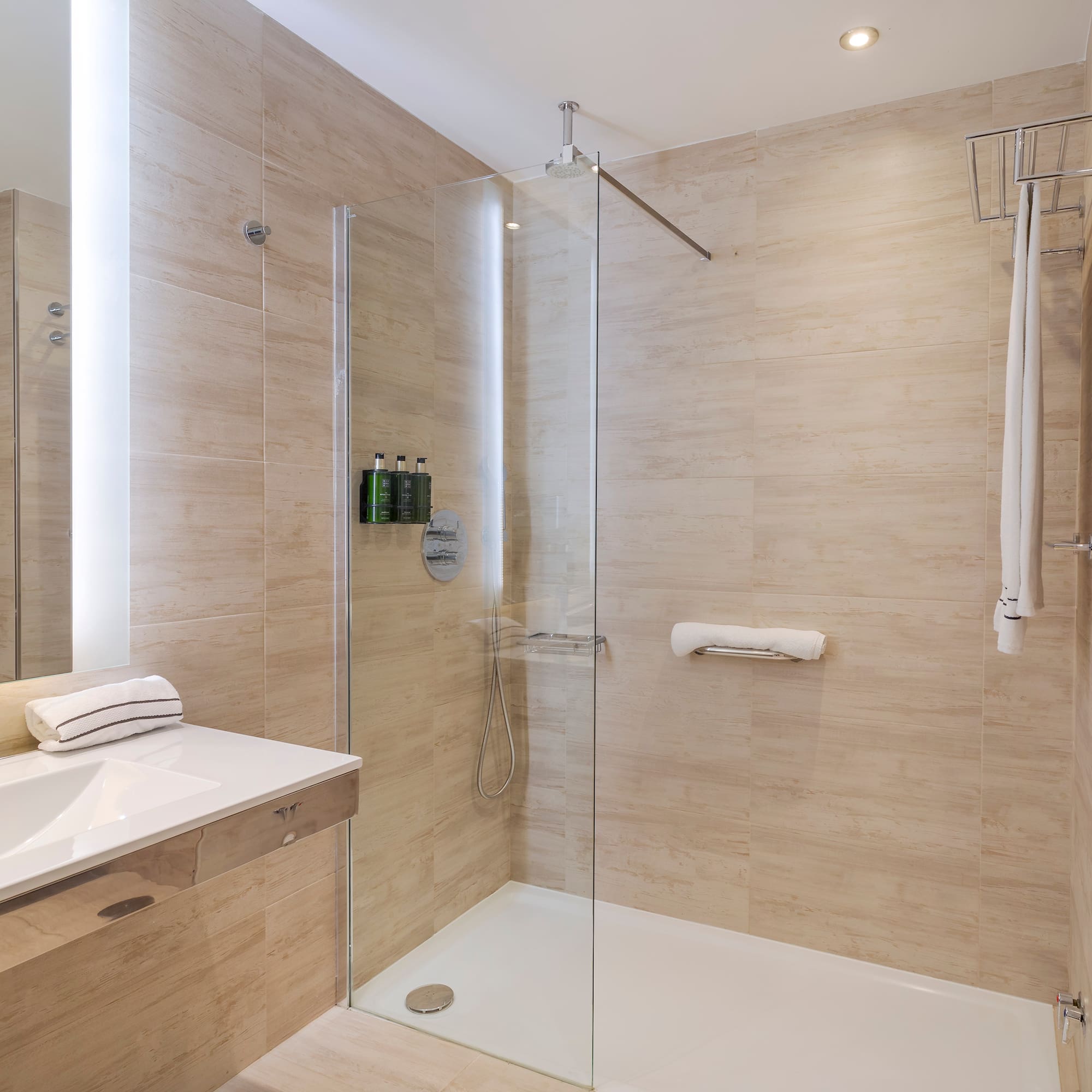 a bathroom with a glass shower and sink