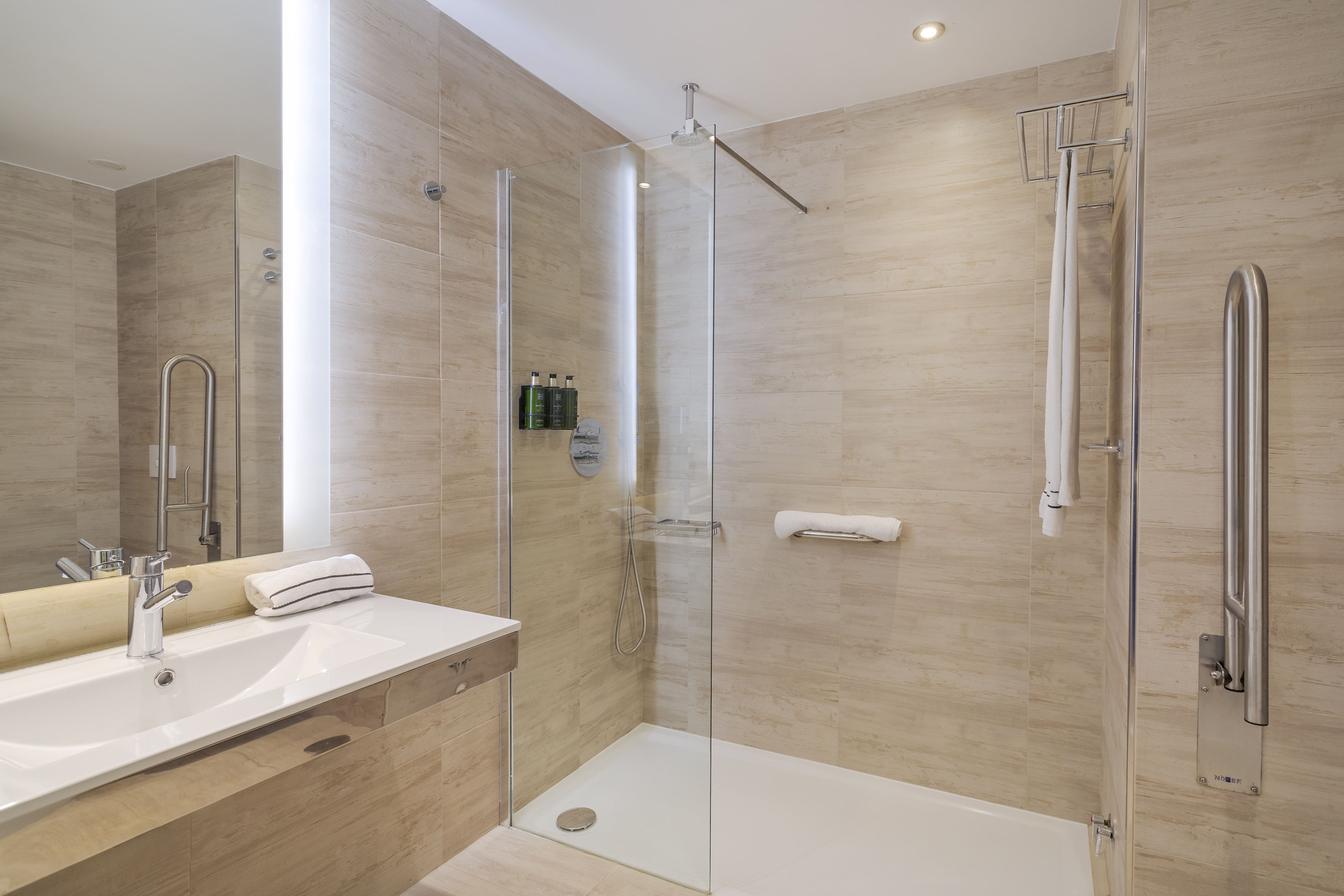 a bathroom with a glass shower and sink