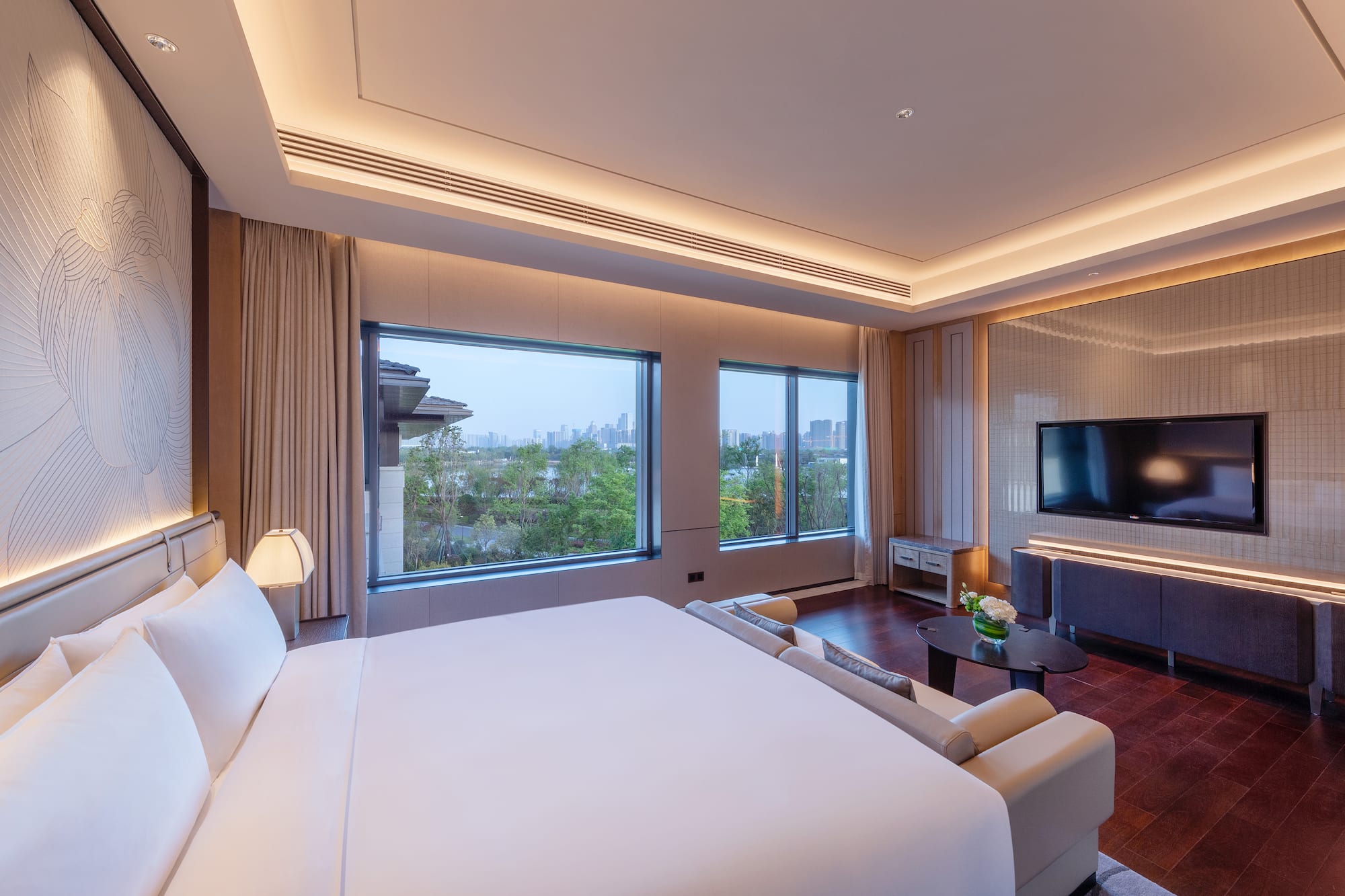 a room with a large bed and a television