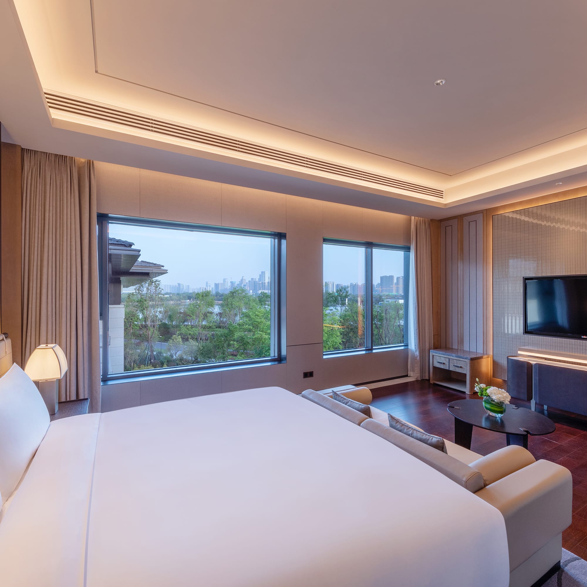 a room with a large bed and a television