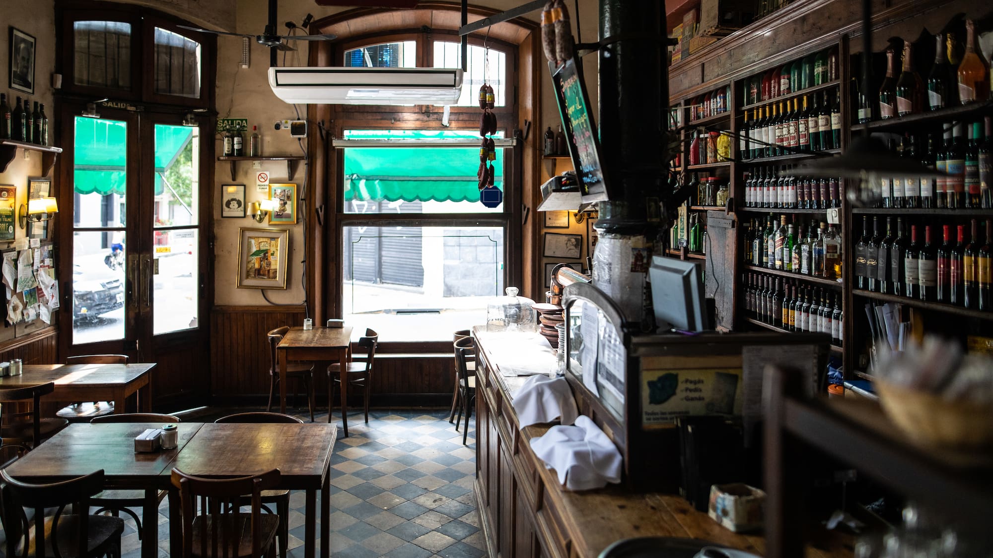 a room with a bar and shelves of bottles