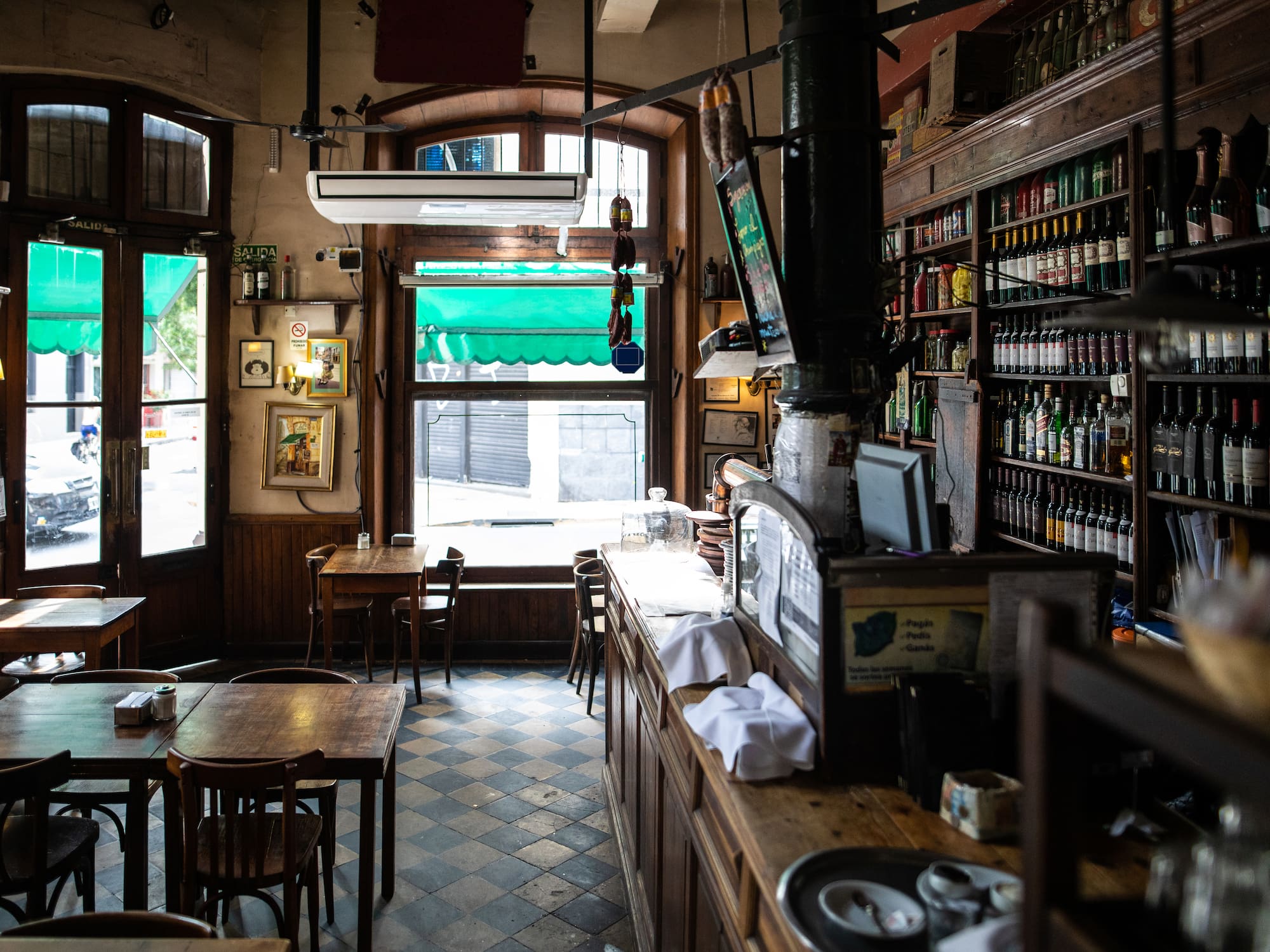 a room with a bar and shelves of bottles