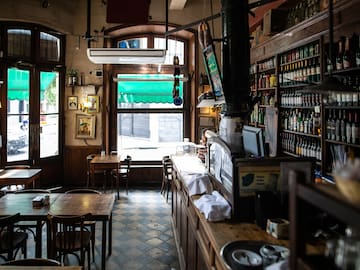 a room with a bar and shelves of bottles