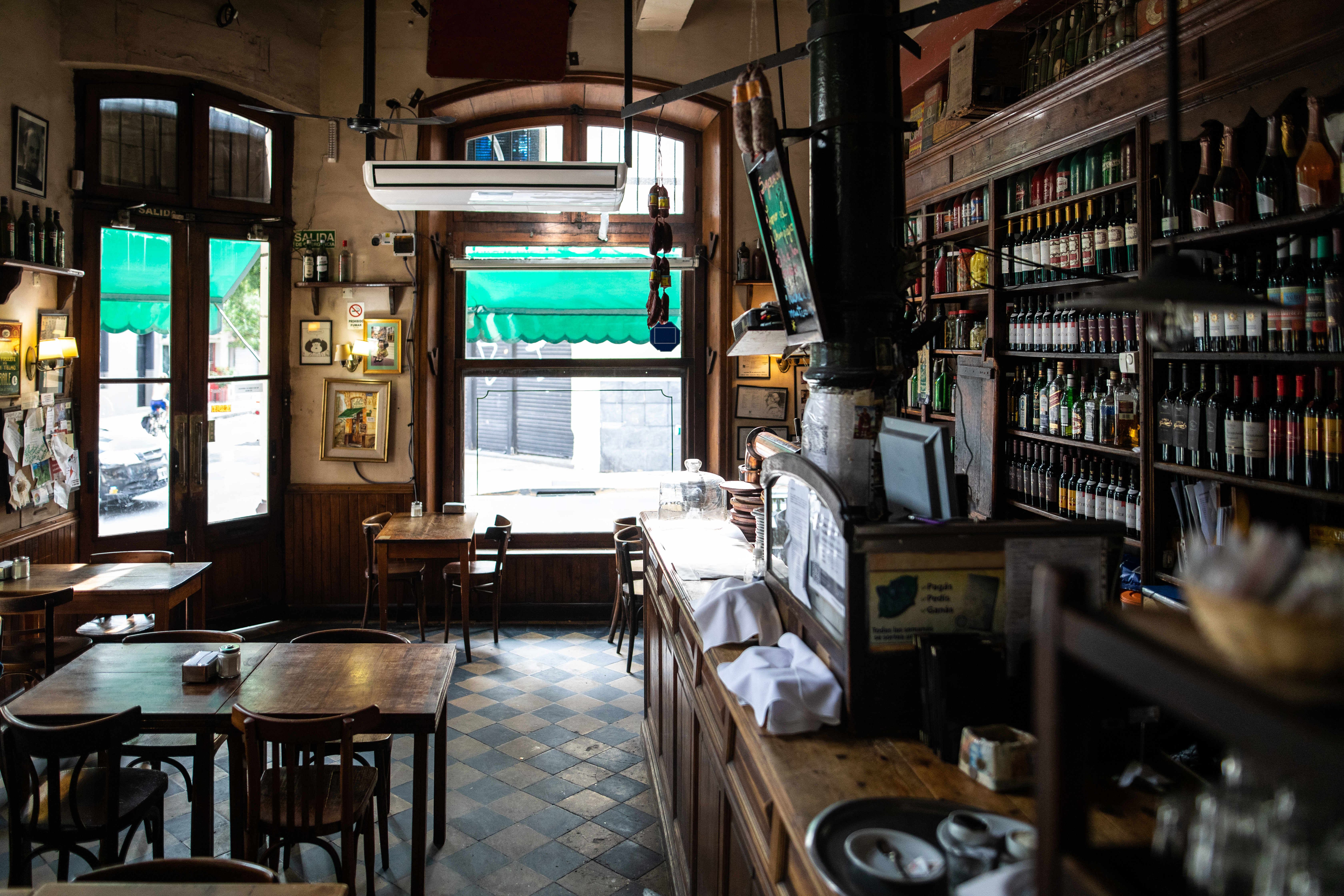 a room with a bar and shelves of bottles