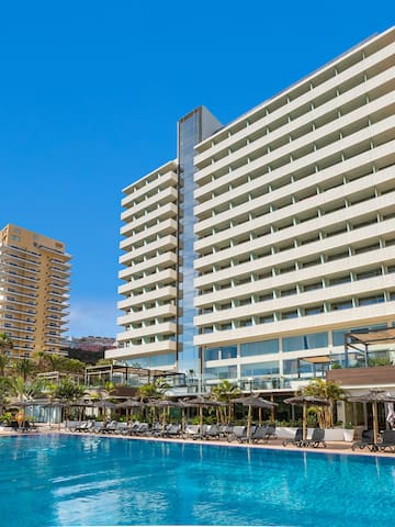 a swimming pool with a large building in the background