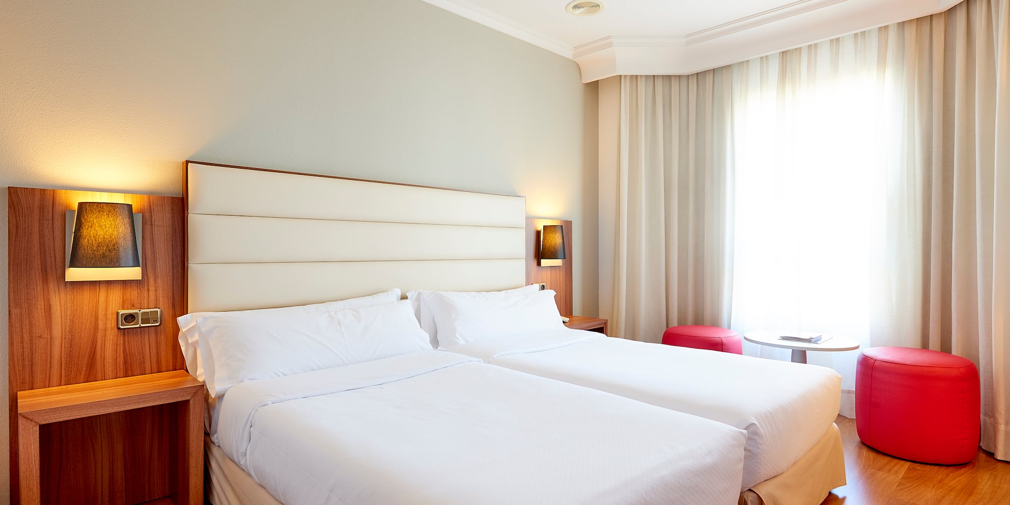 a room with two beds and a window