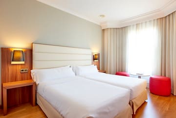 a room with two beds and a window